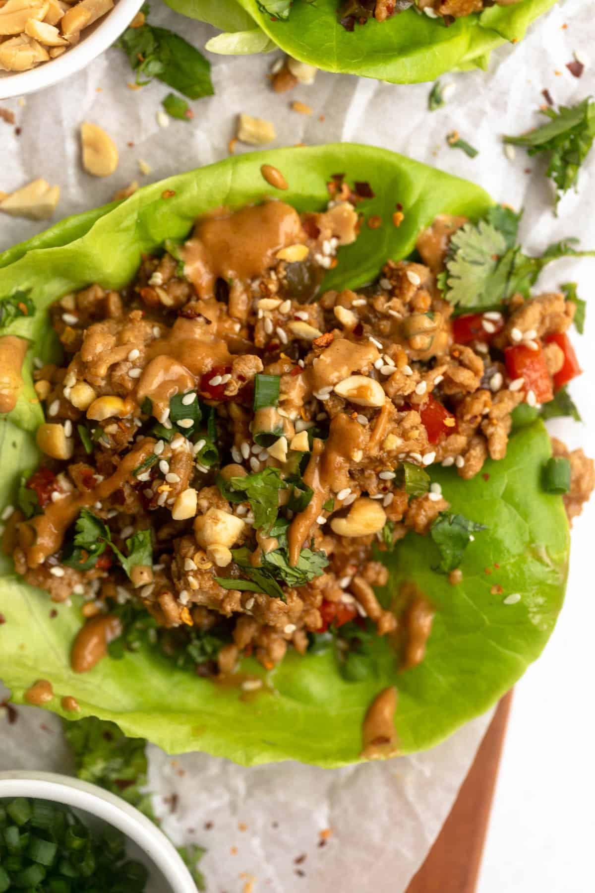 chicken lettuce wraps with peanut sauce on top