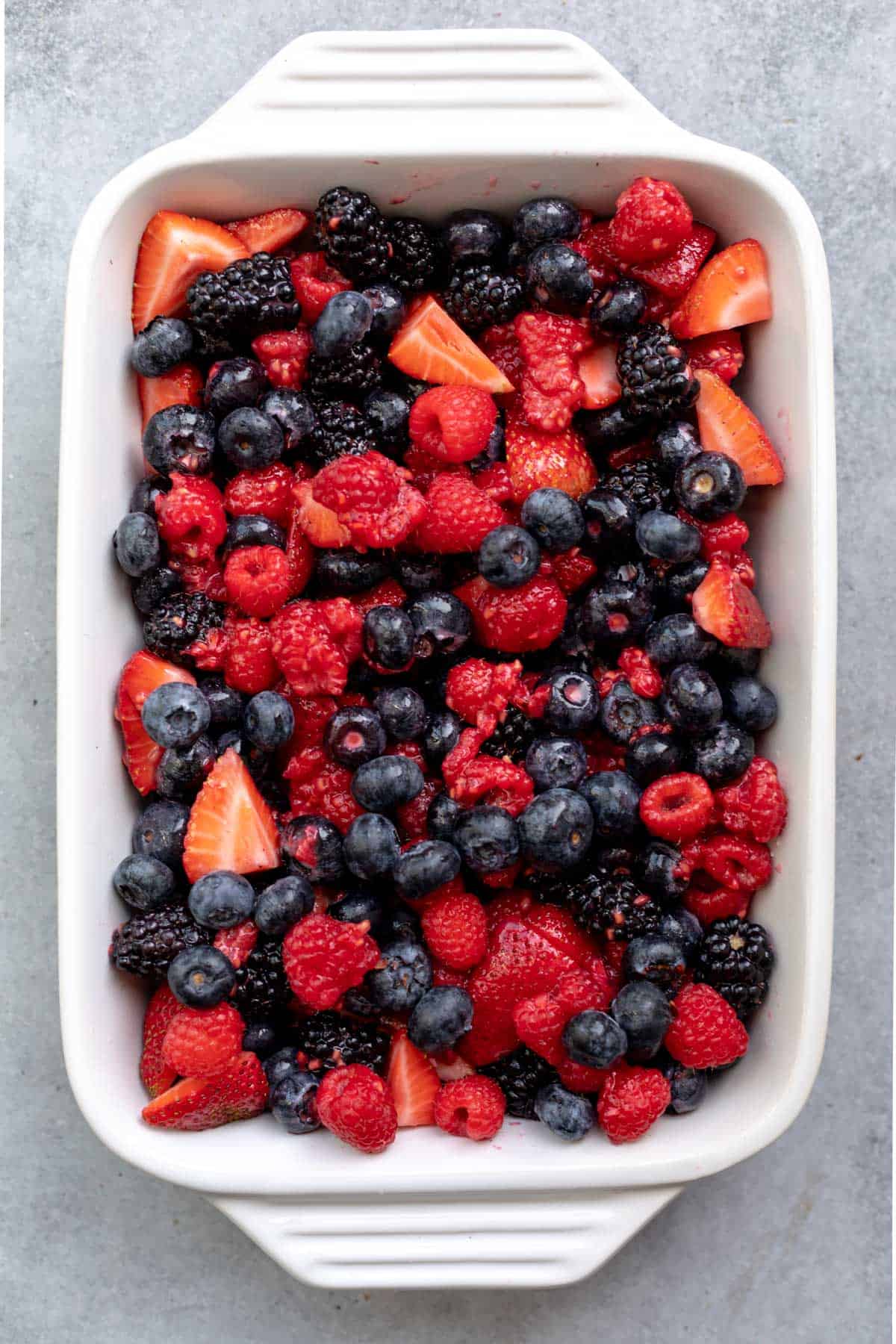 berries in a baking dish before adding the topping