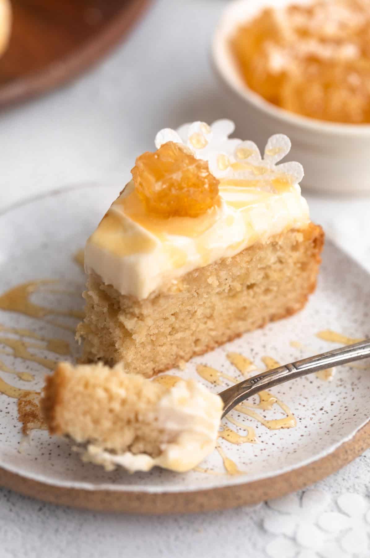 gluten free honey cloud cake on a plate with a fork taking a bite
