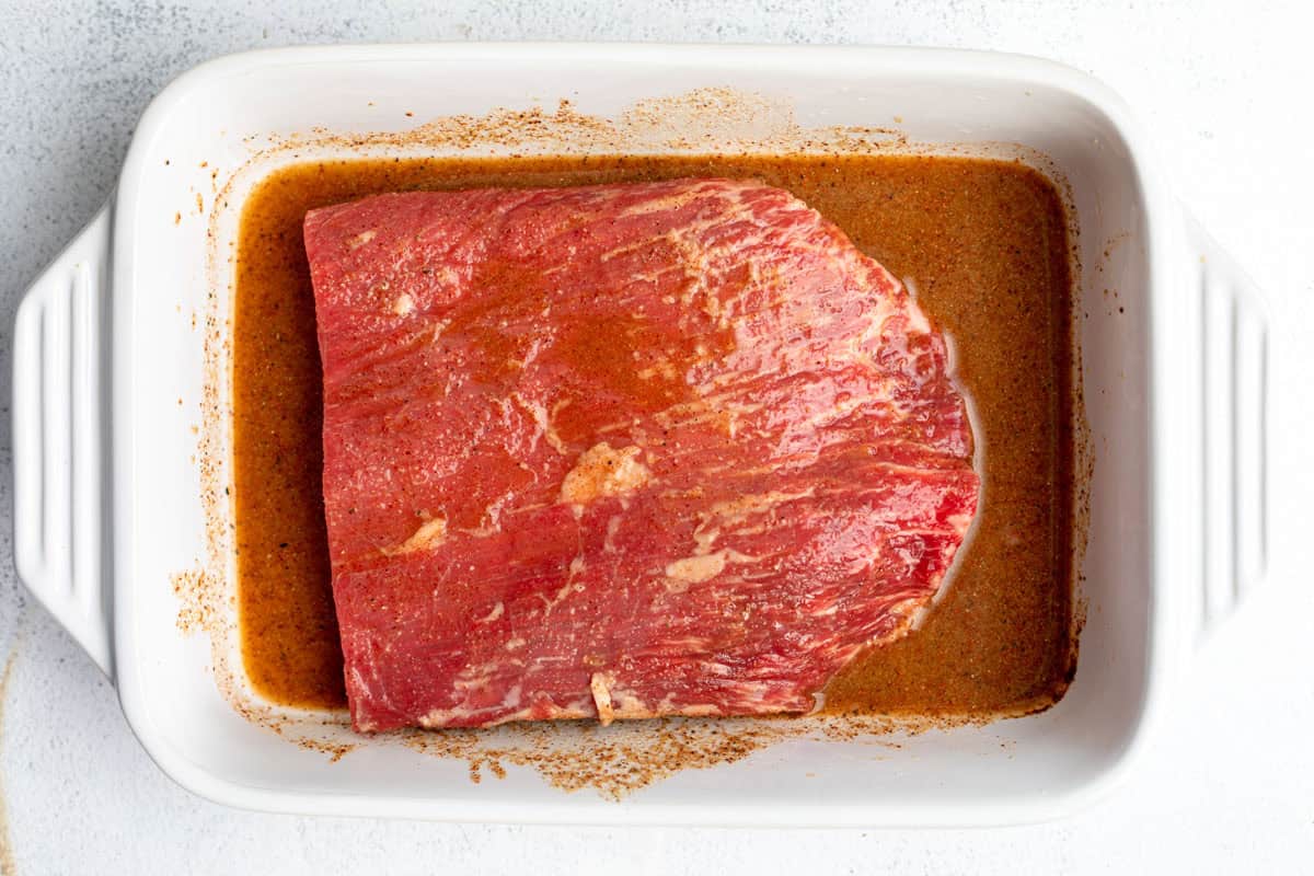 steak marinating in a dish
