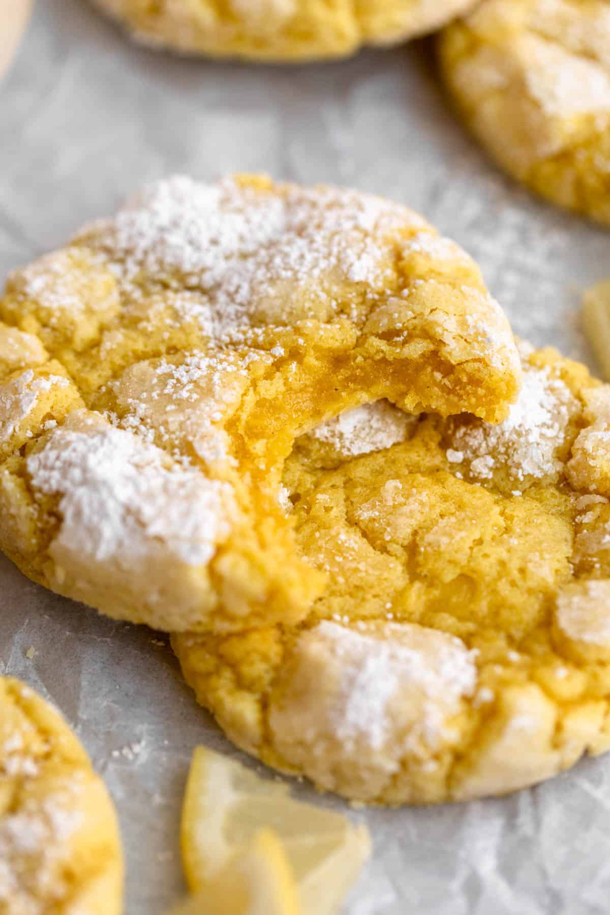 bite taken out of the lemon crinkle cookie to show texture
