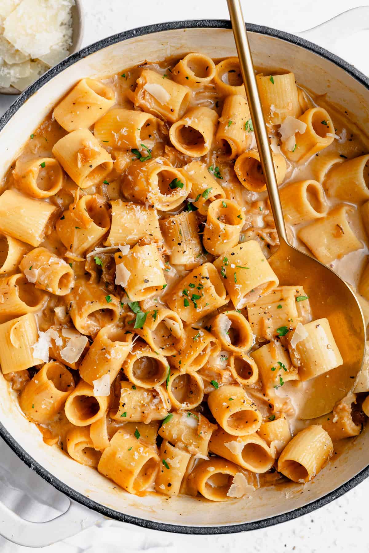 french onion soup pasta in a baking dish with a large spoon