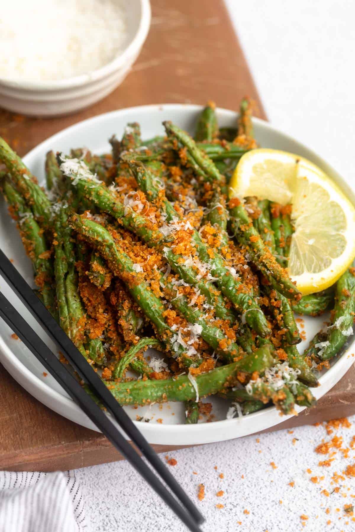 angled view of the air fryer green beans with parmesan on top