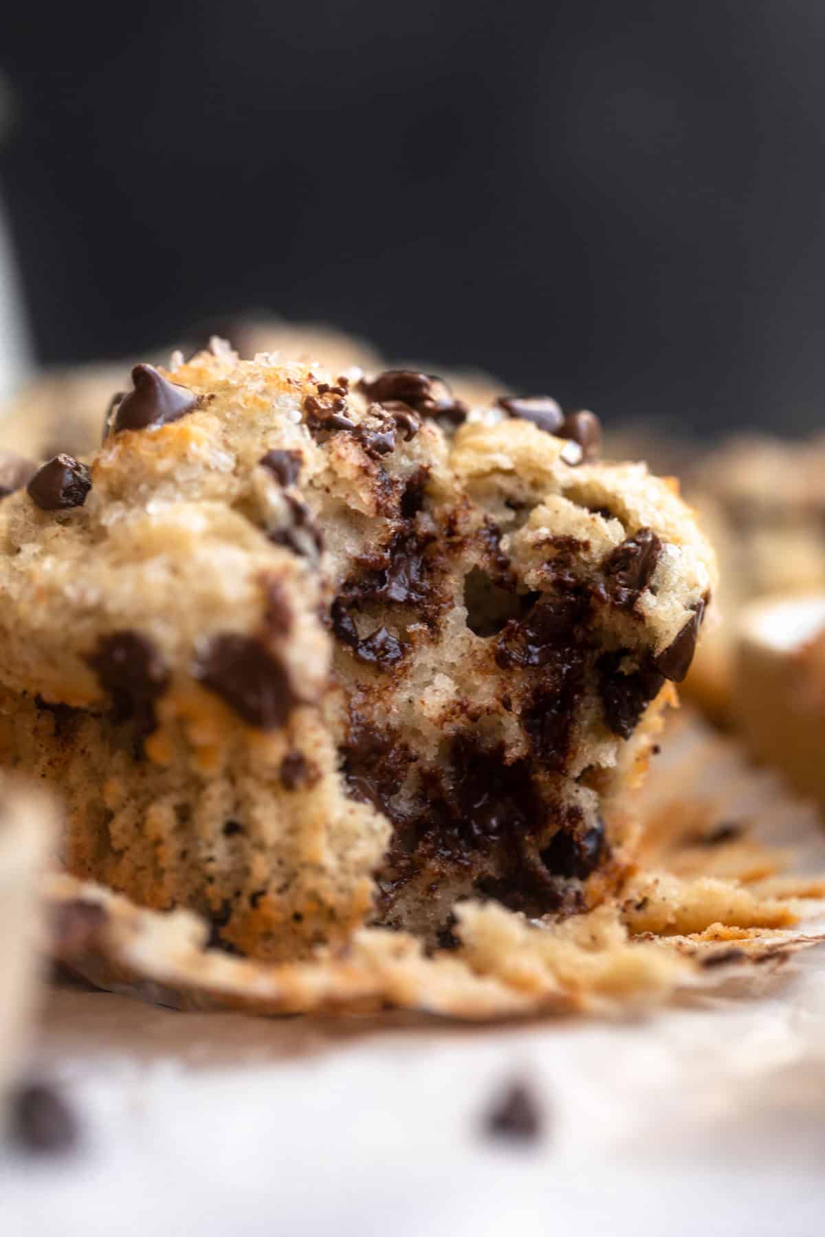 bite taken out of the greek yogurt muffin with chocolate chips