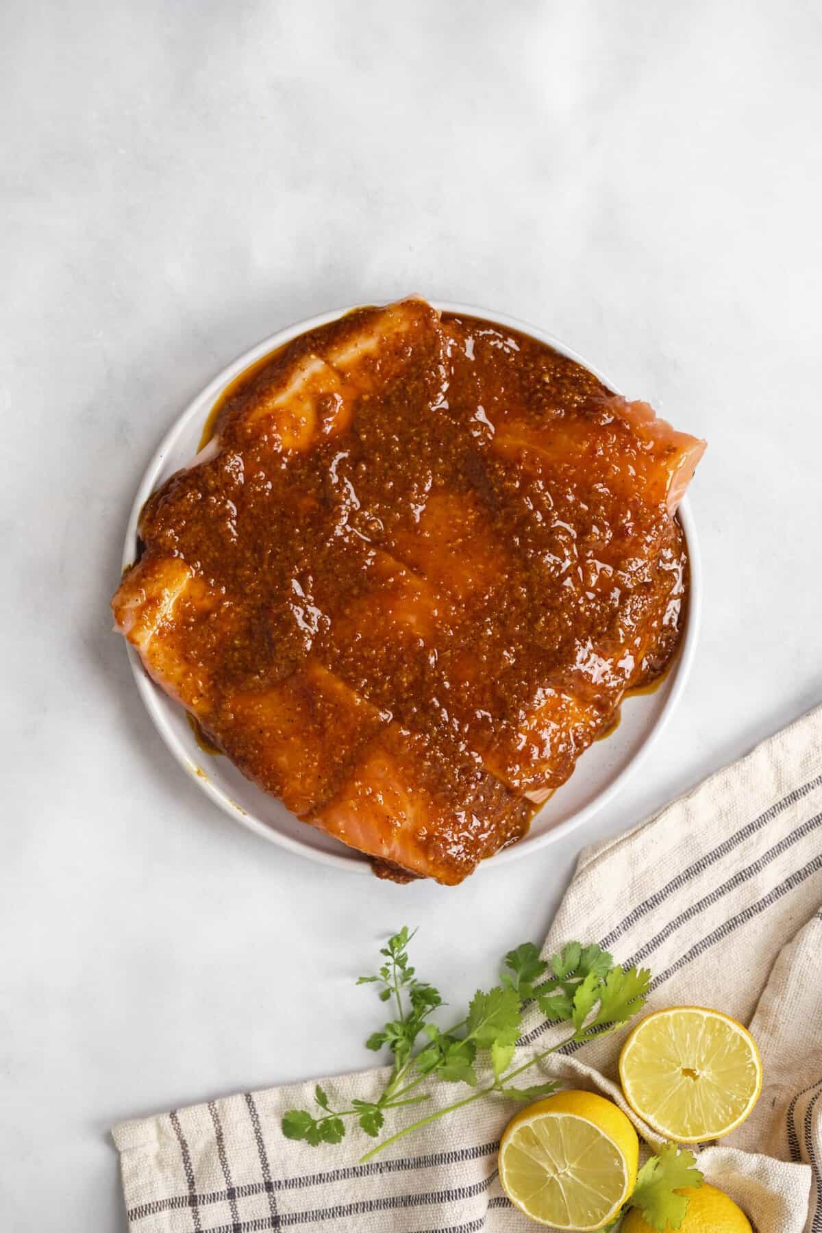 salmon marinating on a plate