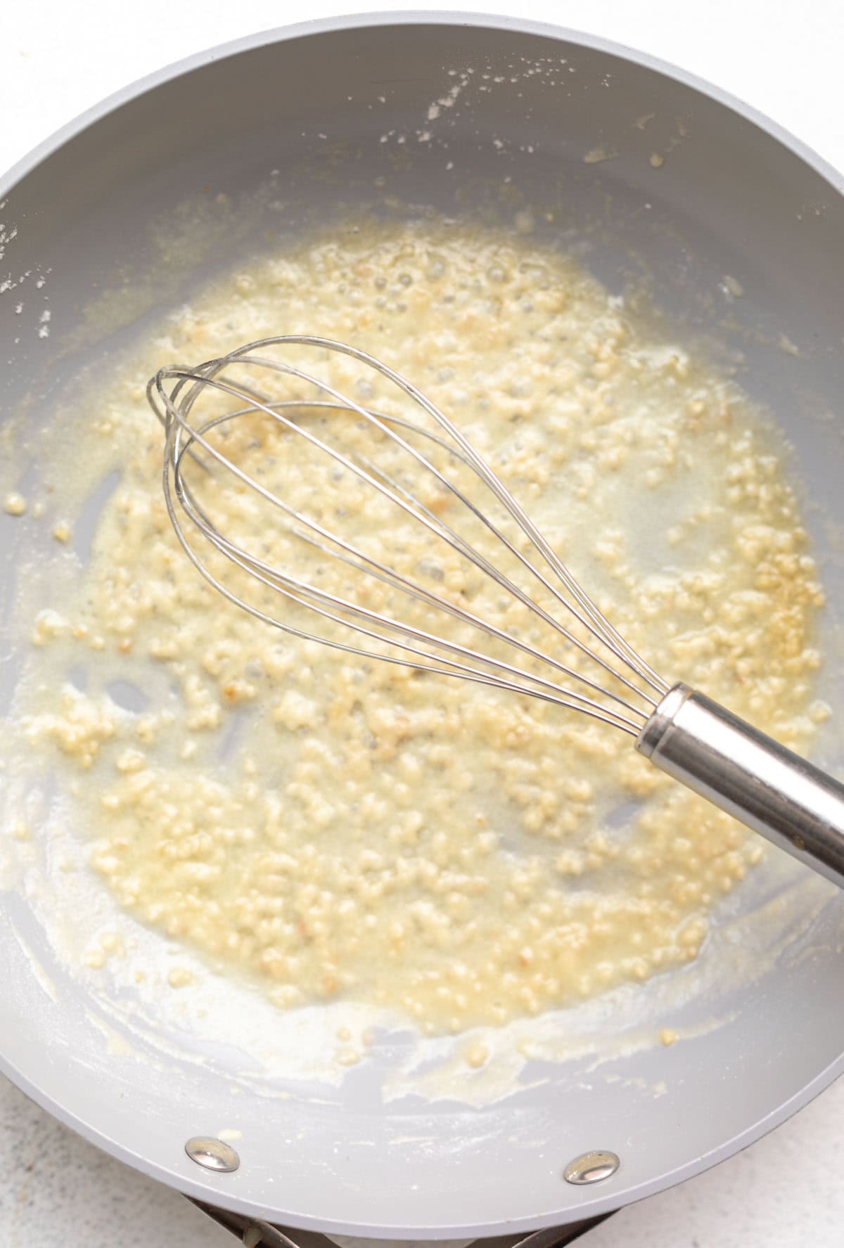 sauteeing the garlic in a skillet