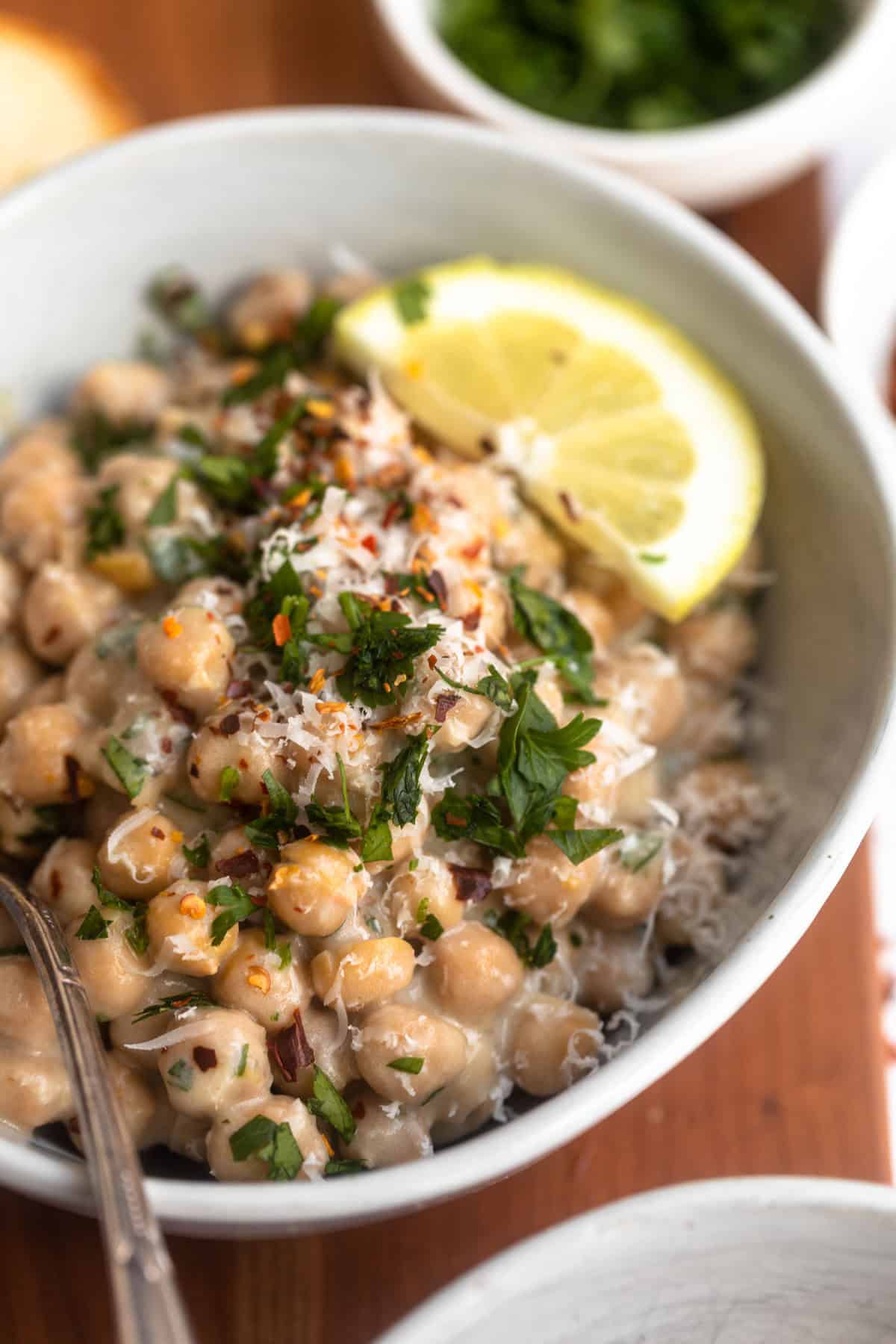 angled view of the lemon pepper chickpeas in a bowl with parsley