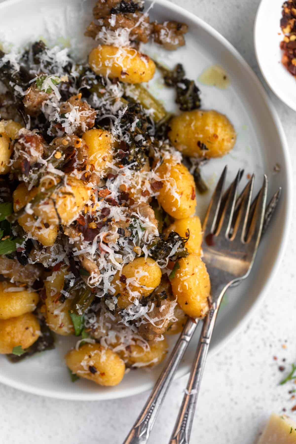 sheet pan gnocchi on a plate with sausage and parmesan