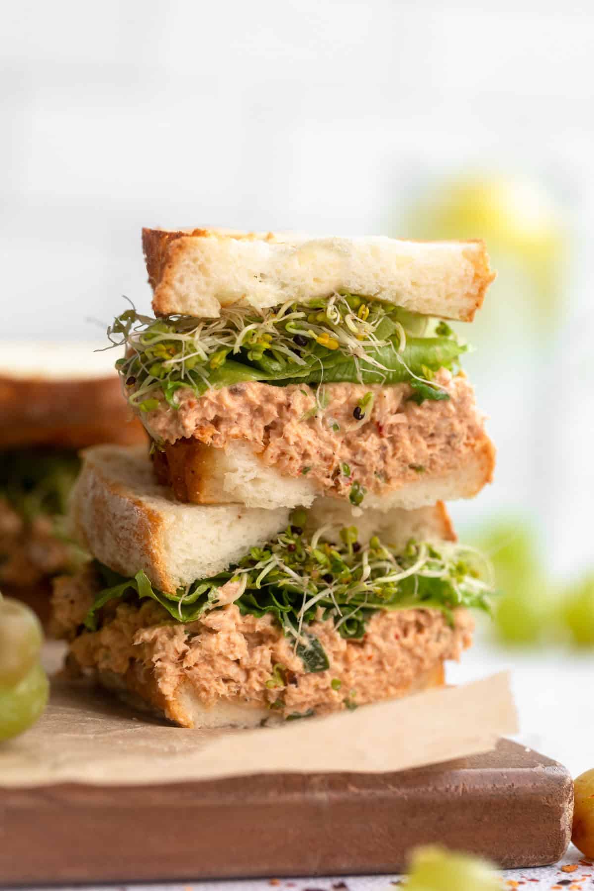 spicy salmon salad sandwich cut in half stacked on each other