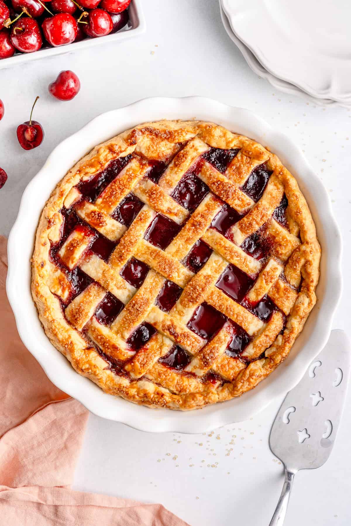 overhead shot of the gluten free cherry pie in a pie pan with sugar on top