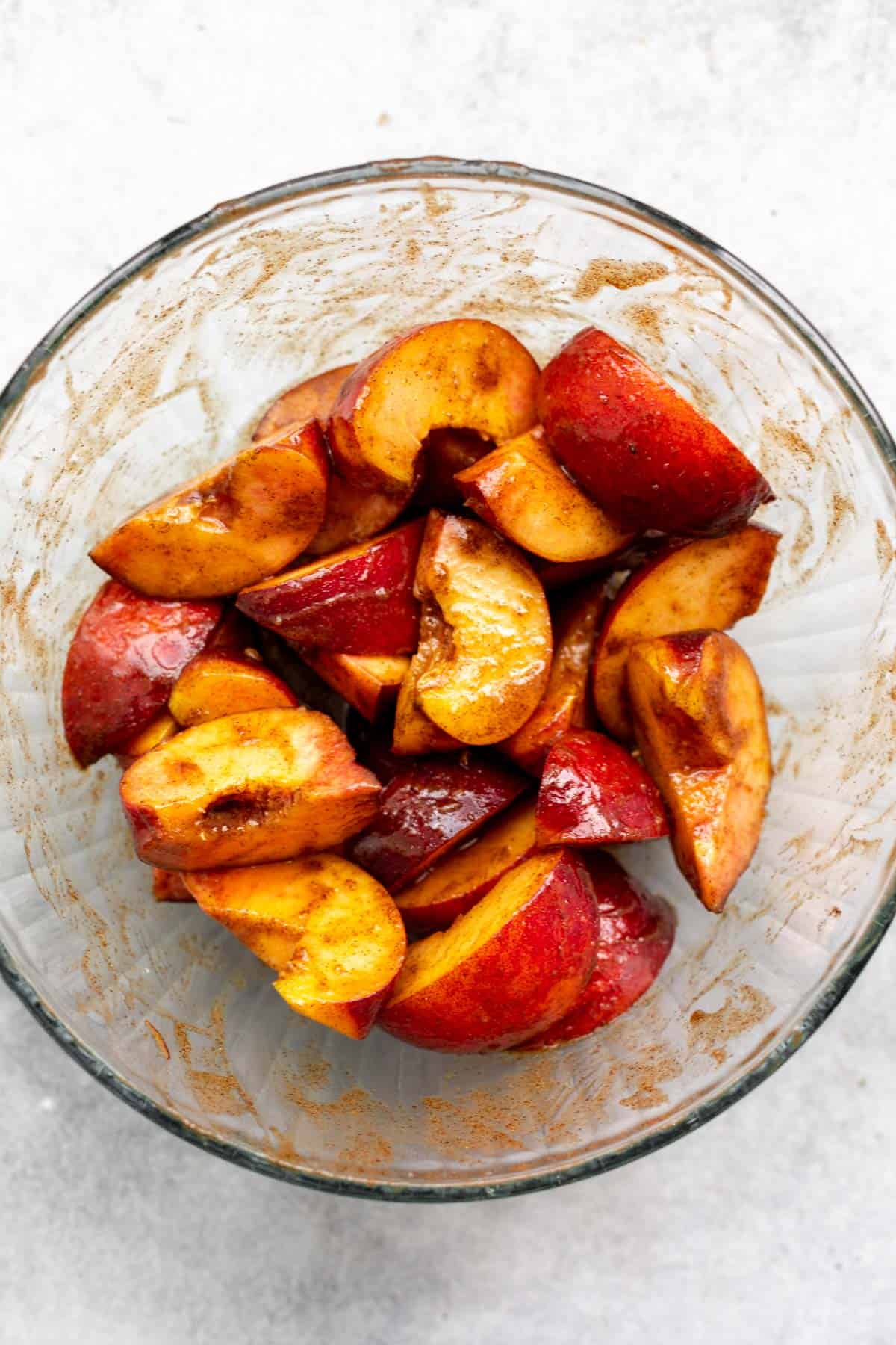 fruit in a bowl coated with cinnamon sauce