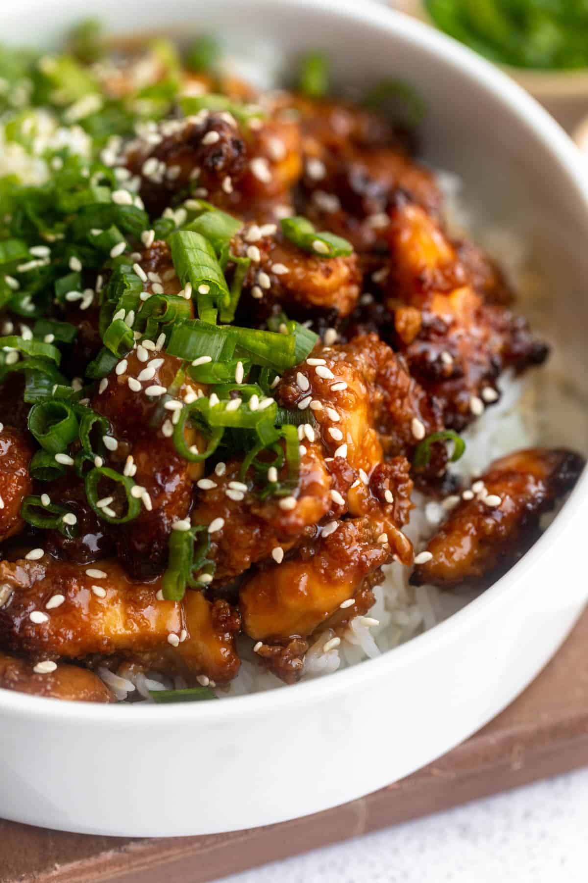 angled view of the teriyaki chicken in a bowl with rice