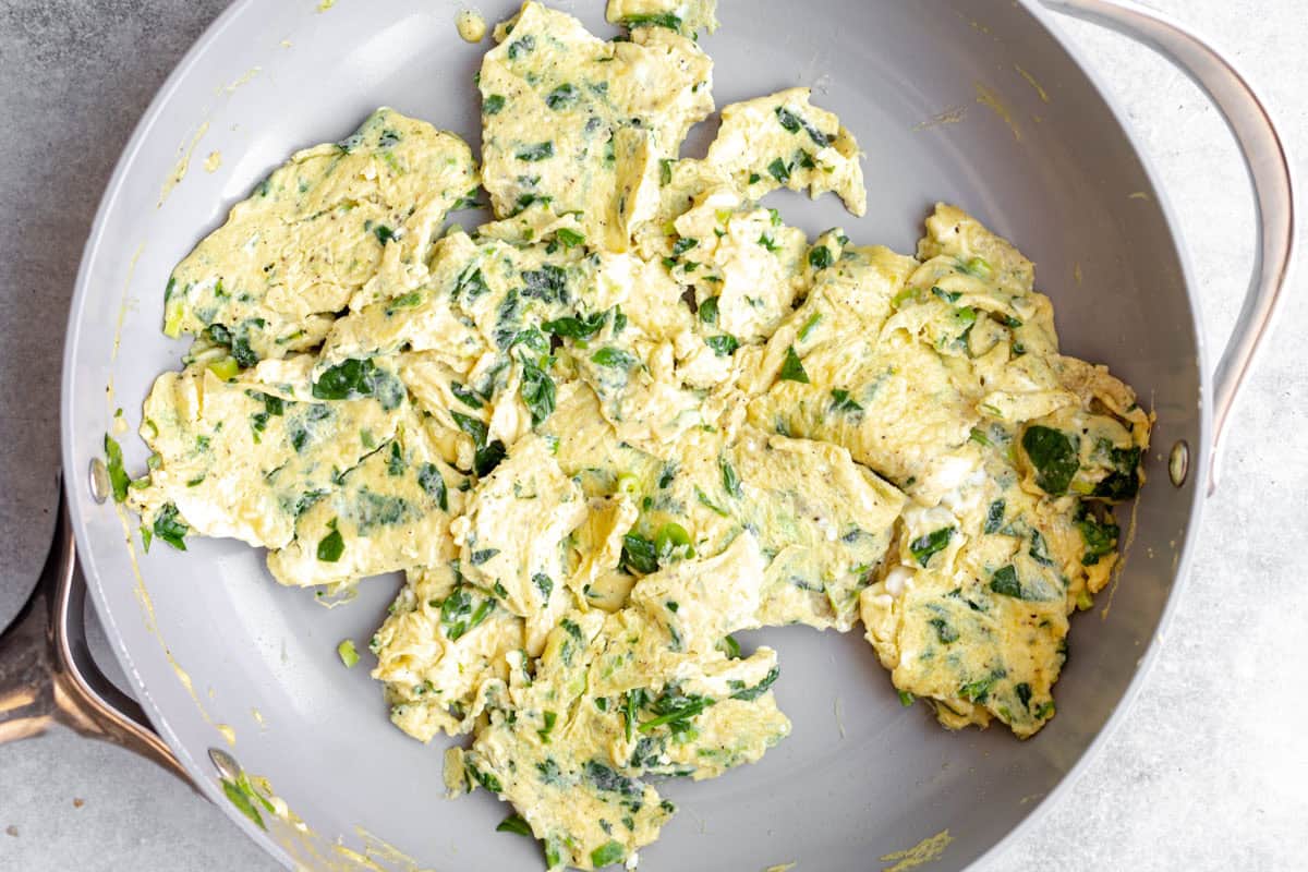 eggs scrambled in a pot with spinach