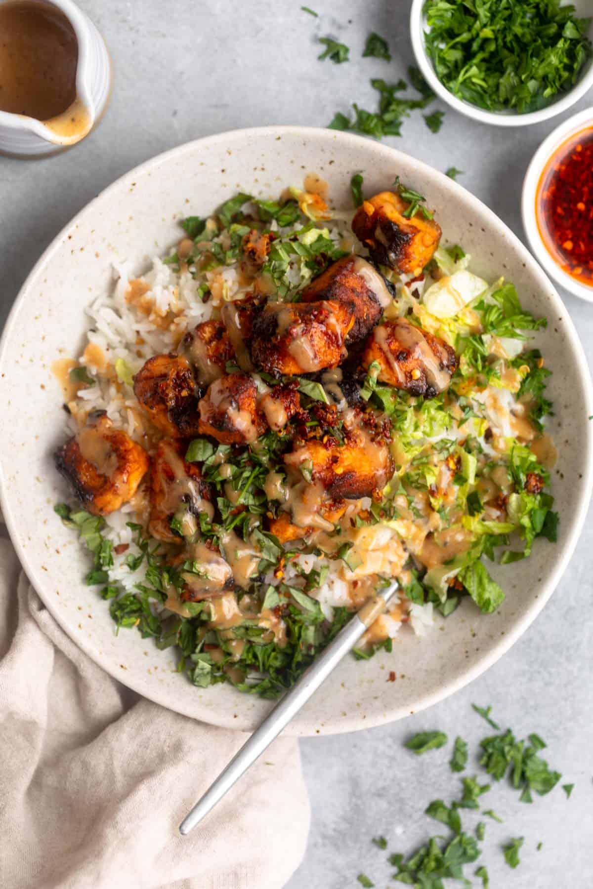 honey mustard salmon bowls with veggies and herbs on top