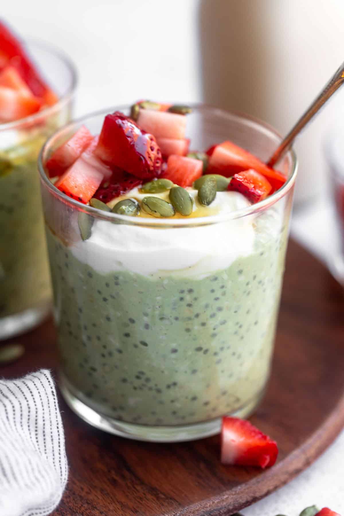 matcha overnight oats with chia seeds and strawberries on top