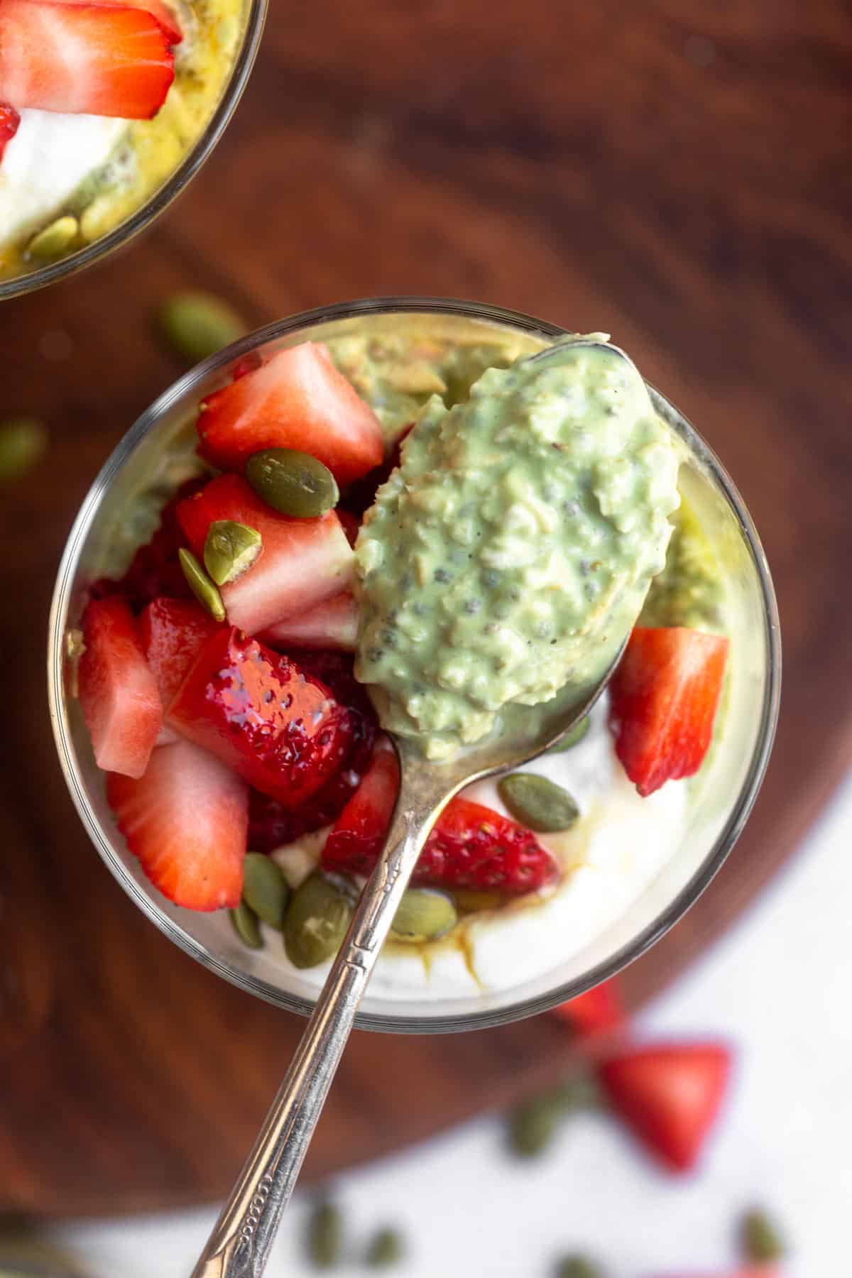 matcha overnight oats in a glass jar with a spoon on the side