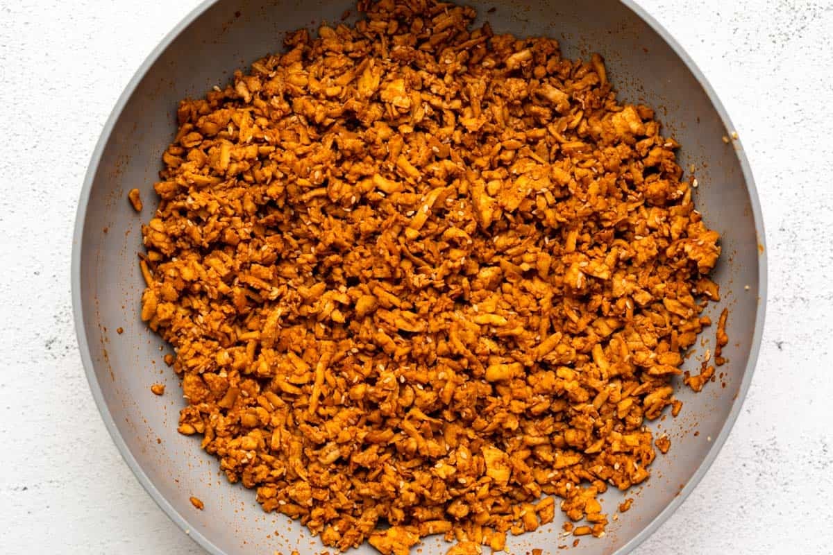 tofu crumbles in a pan after adding the sauce