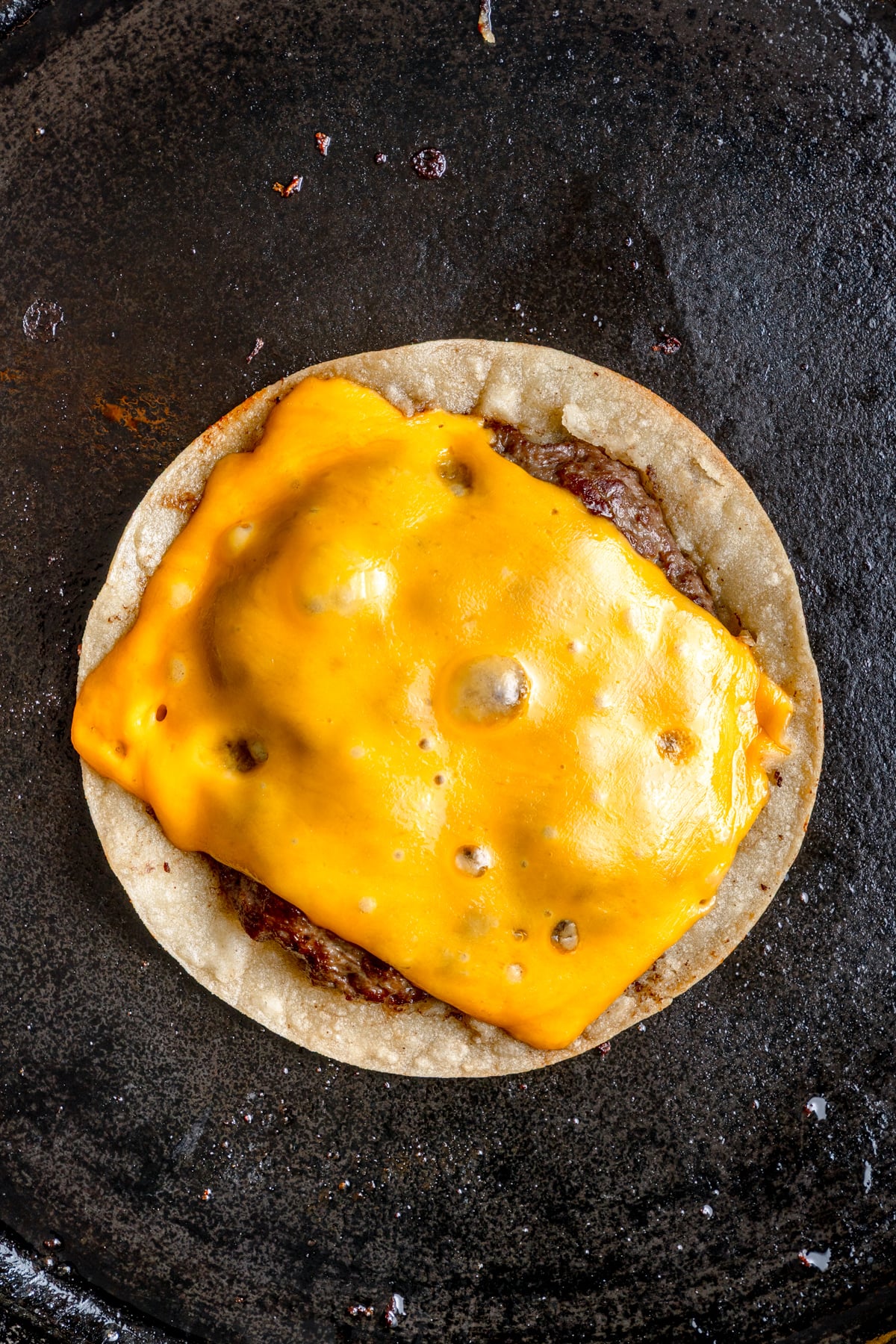 cheese melting on top of the meat