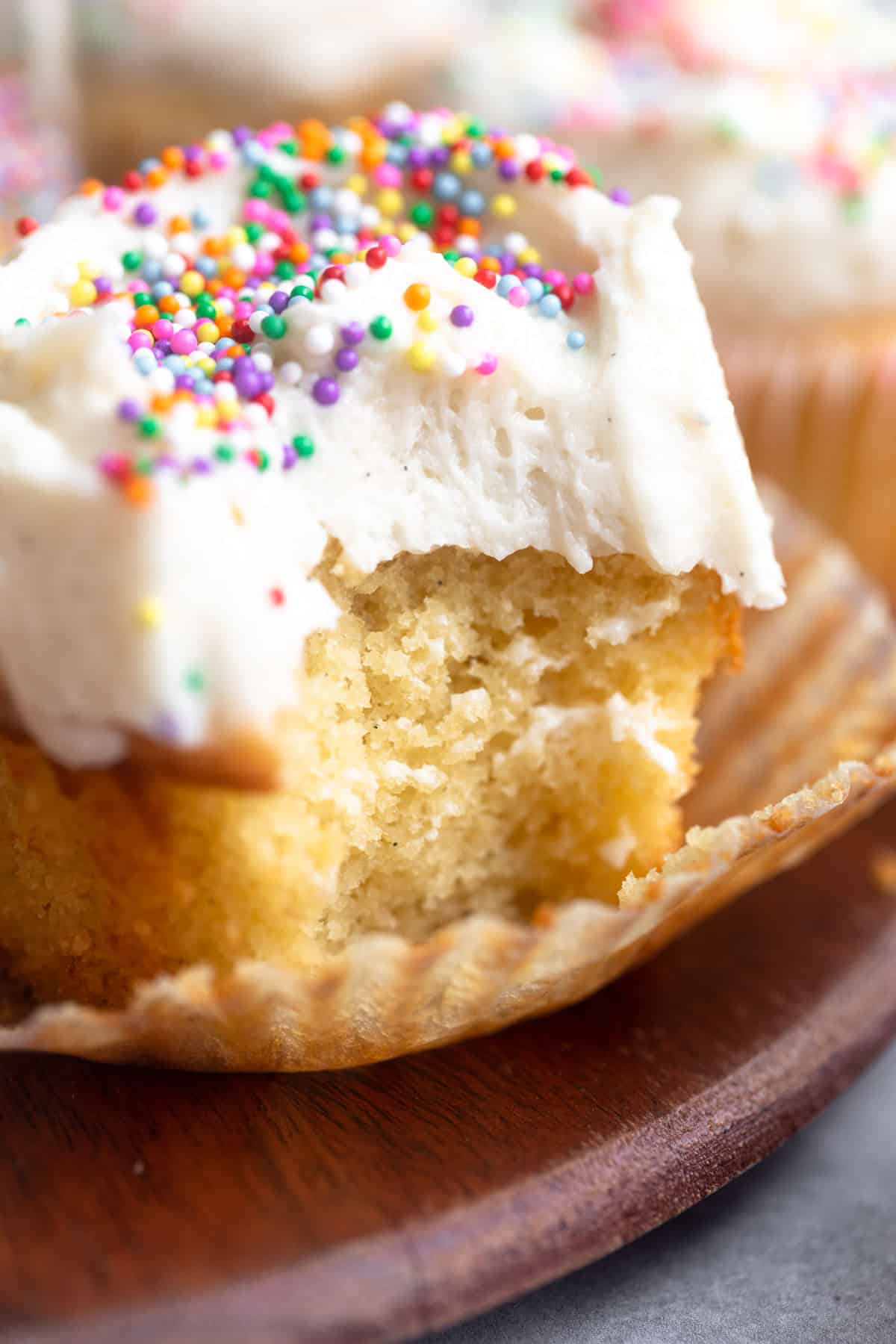 bite taken out of the almond flour vanilla cupcake to show texture