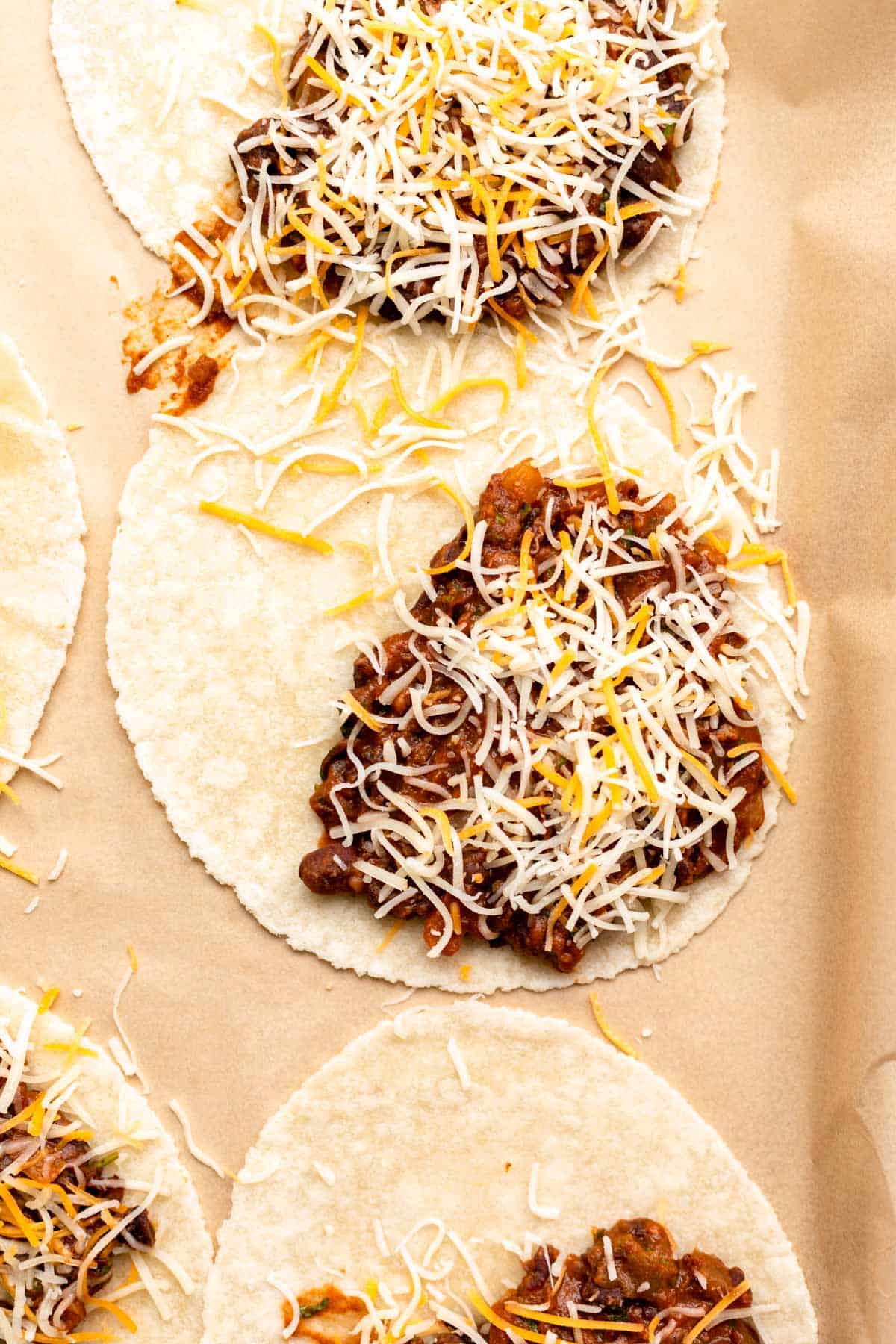 filling tortillas with cheese and the mixture