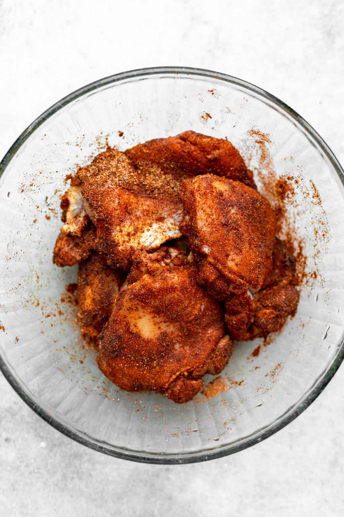 chicken marinating in a bowl