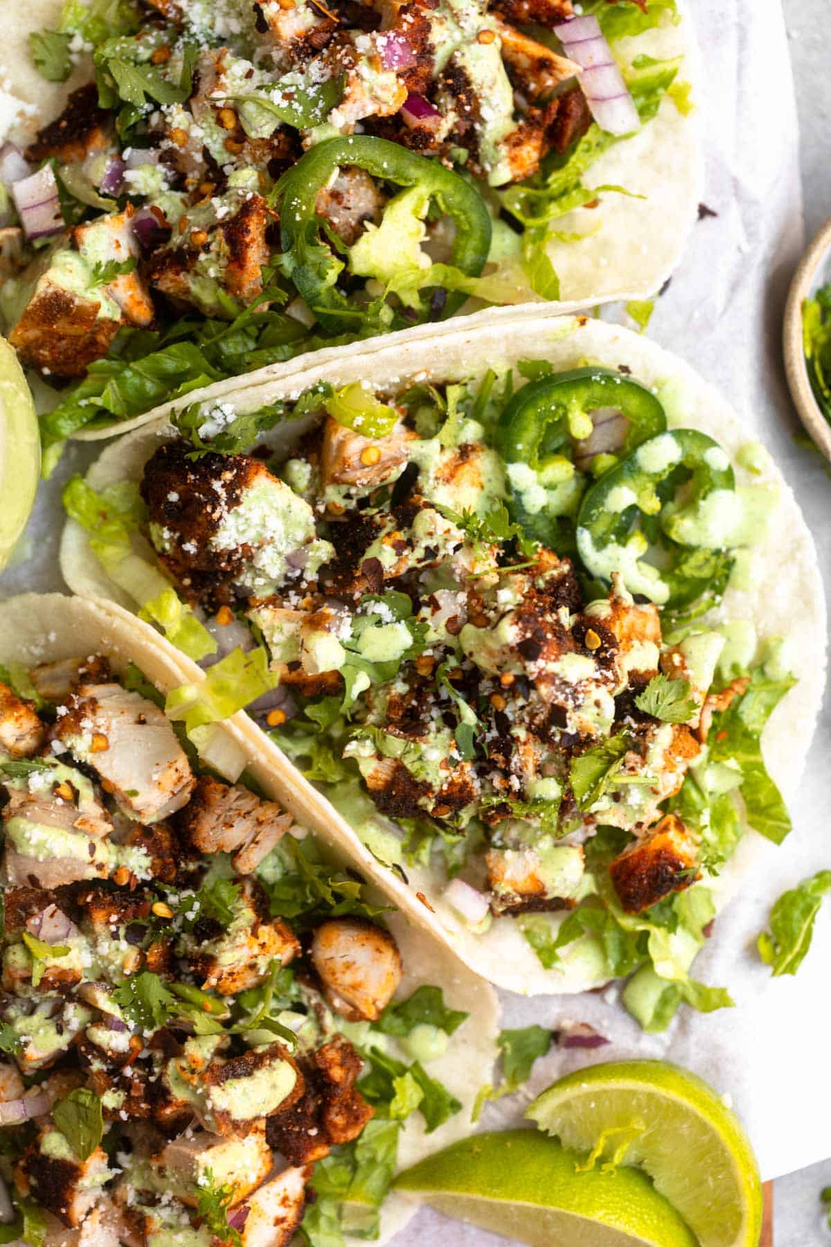 overhead view of the air fryer chicken tacos with green sauce