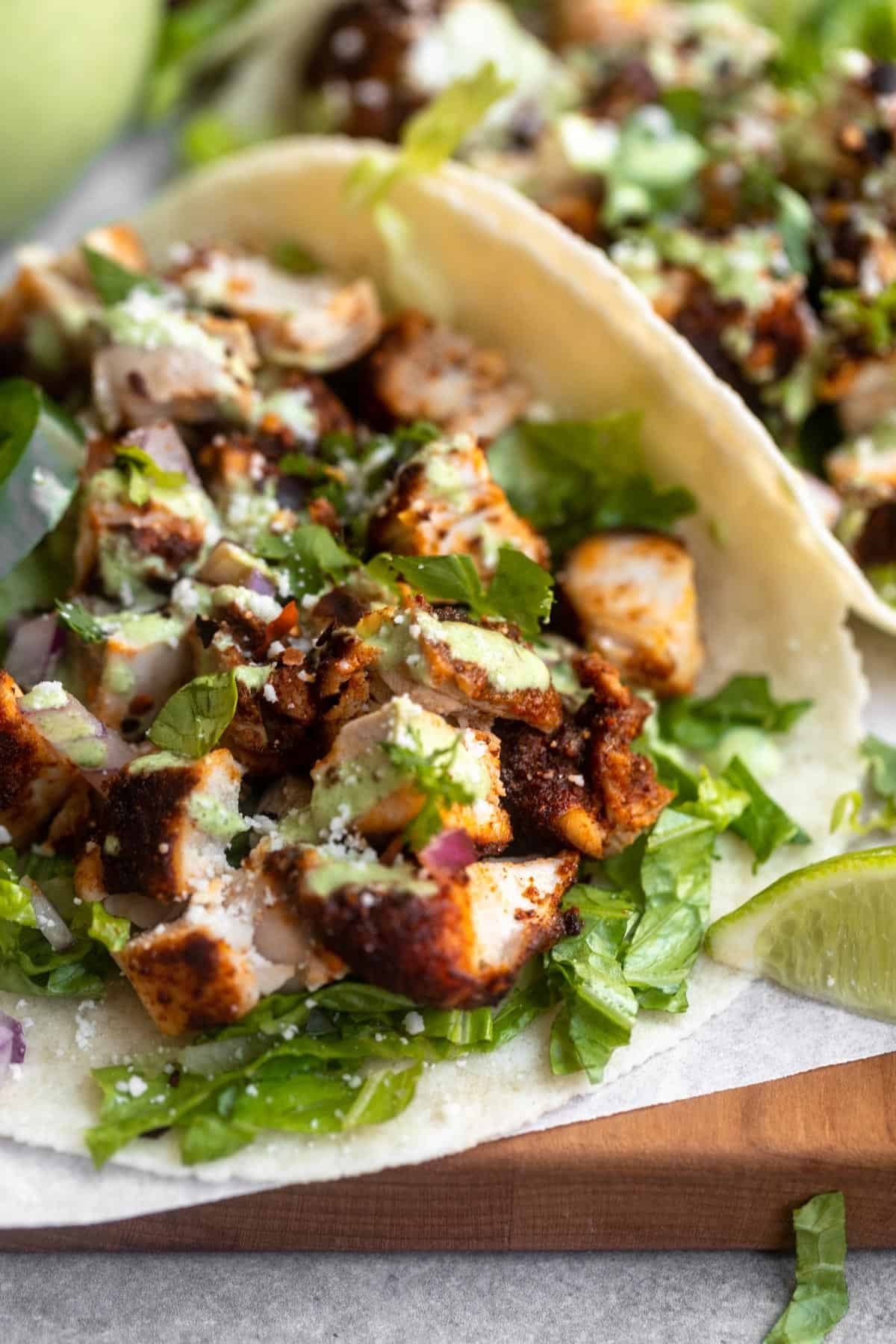 angled view of the air fryer chicken tacos with lettuce