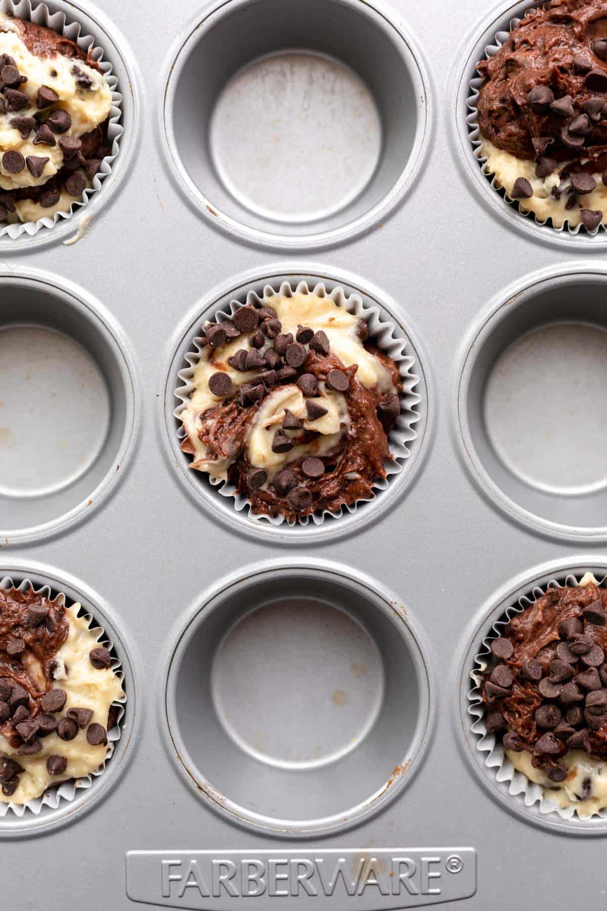 muffins scooped into the muffin tin