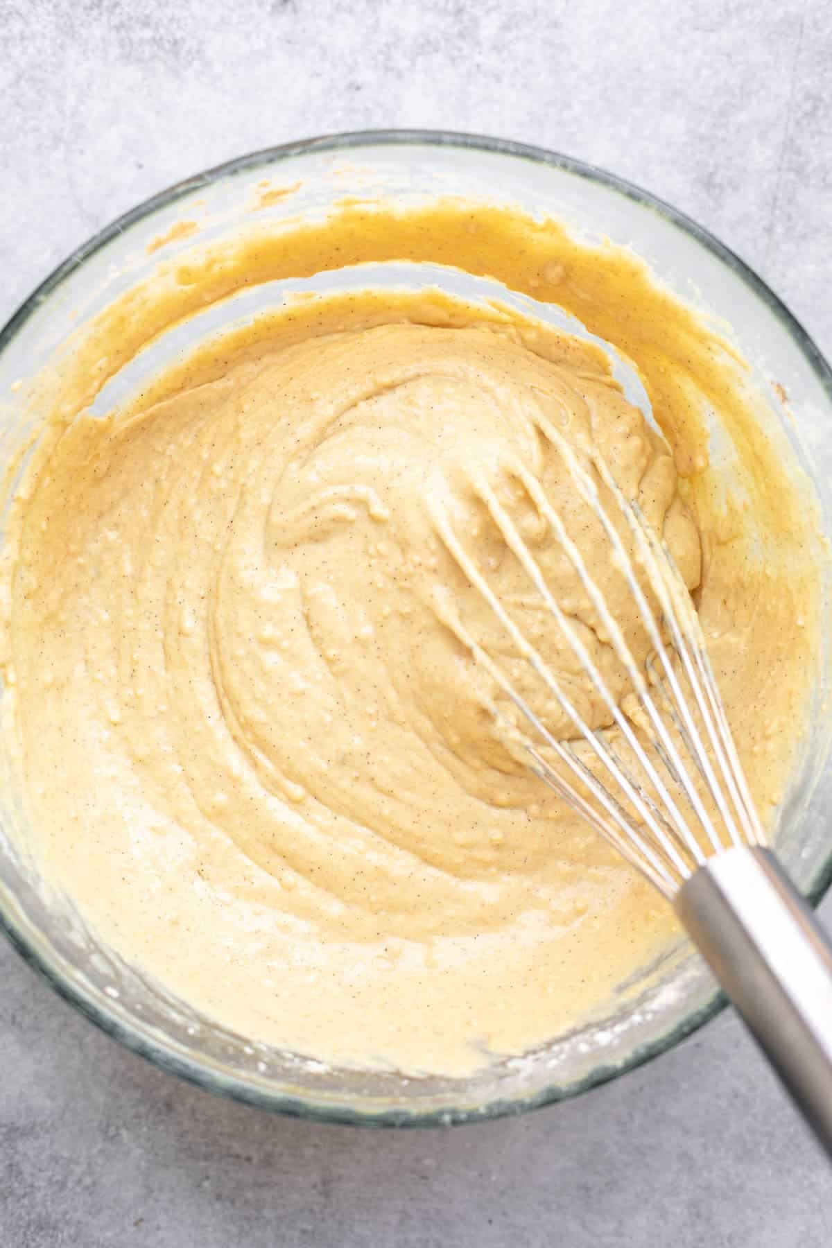 batter in a glass bowl with a whisk