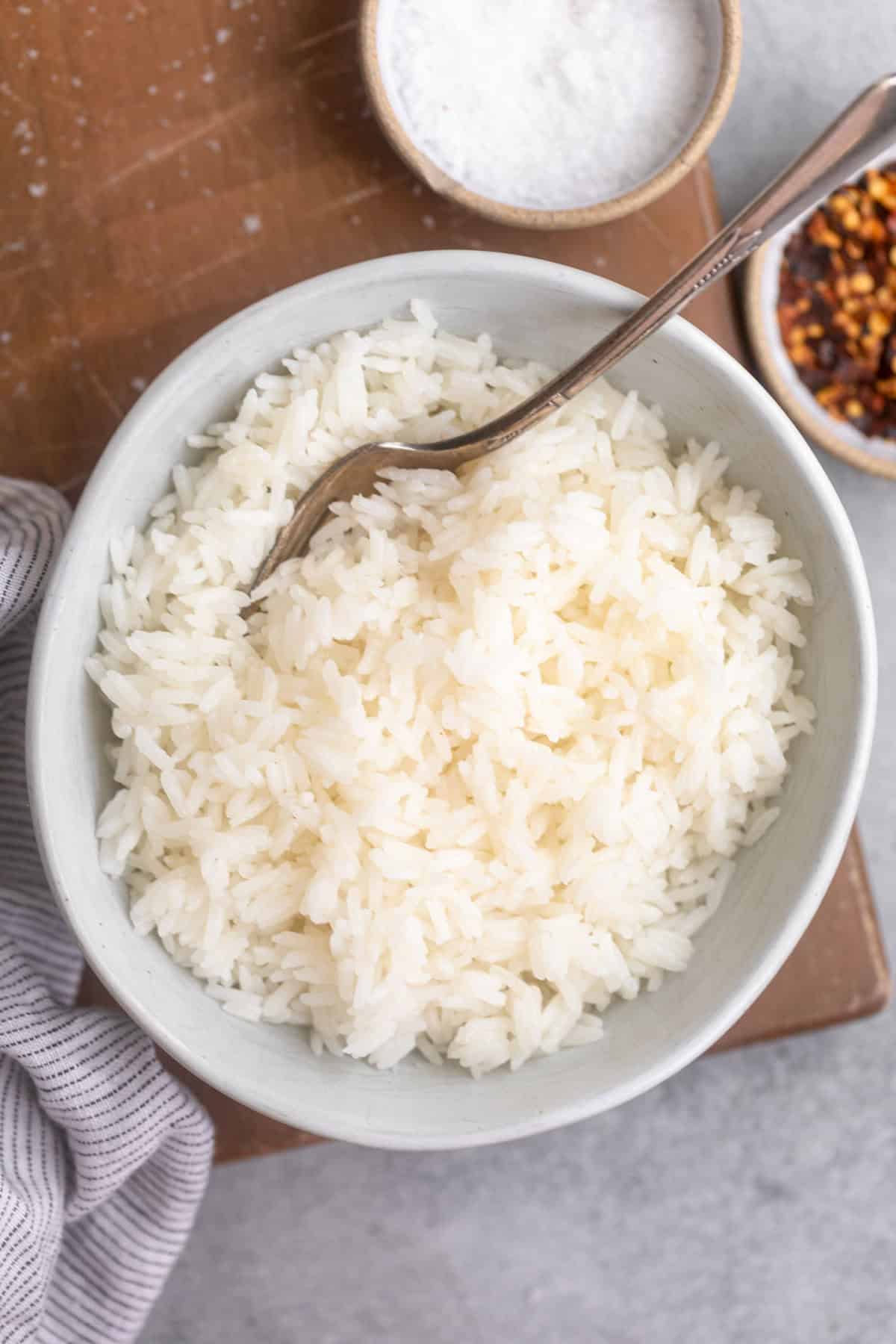 jasmine rice in a bowl with a fork on the side