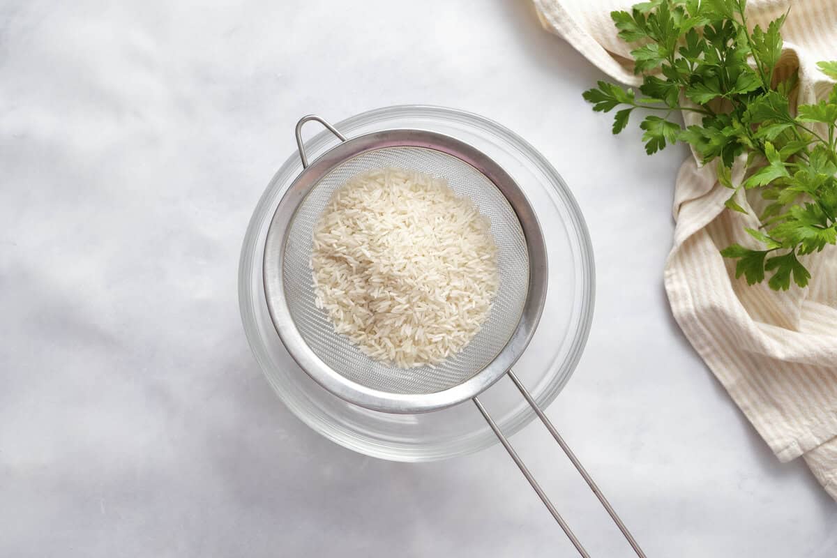 rinsing the rice in a strainer