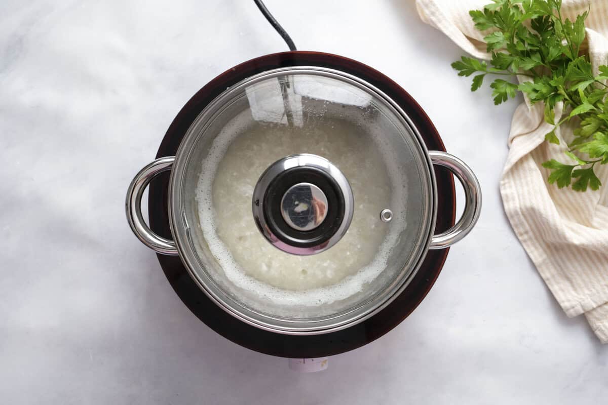 covered rice cooking in a pot