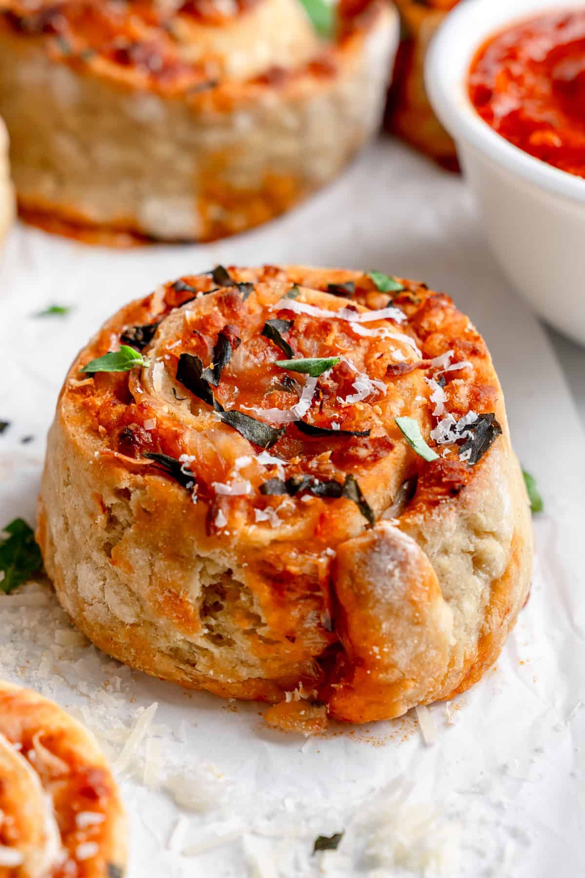 gluten free pizza rolls with parmesan and basil on top