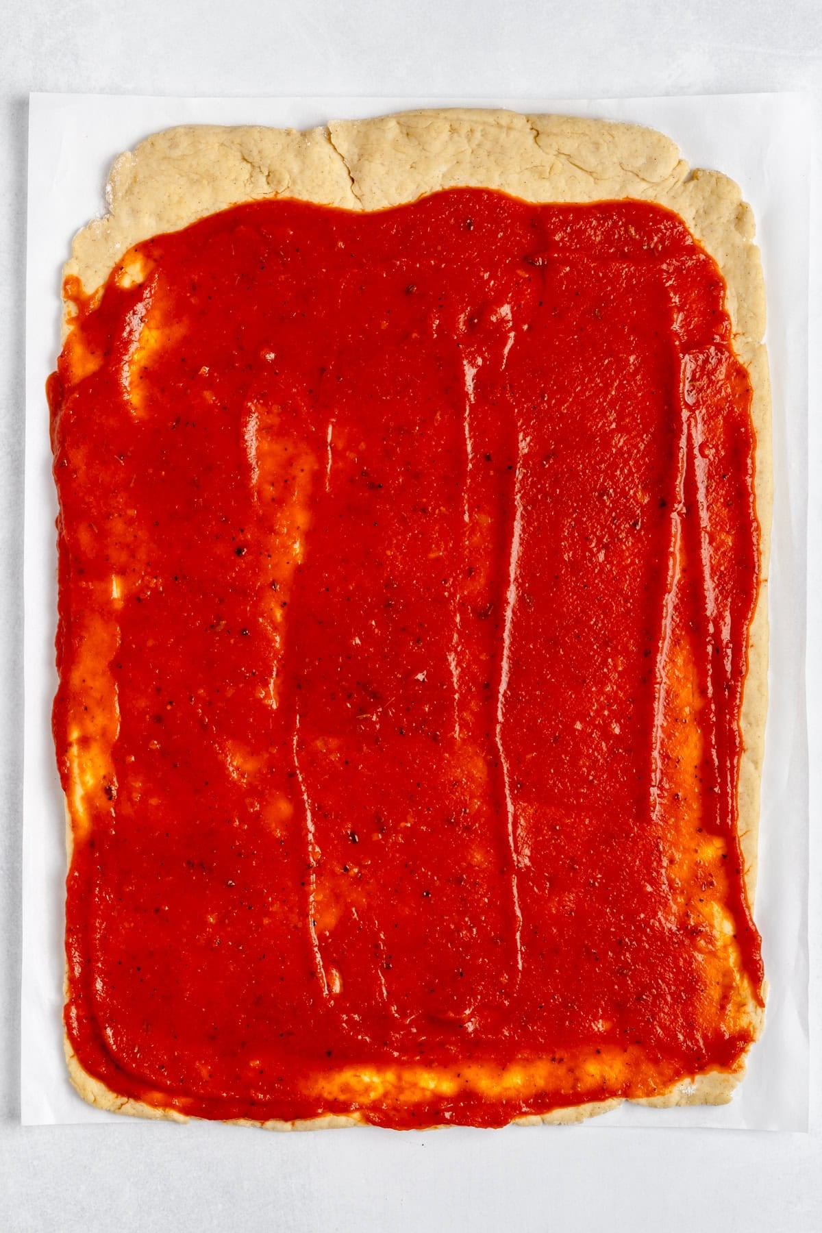 dough with sauce on top