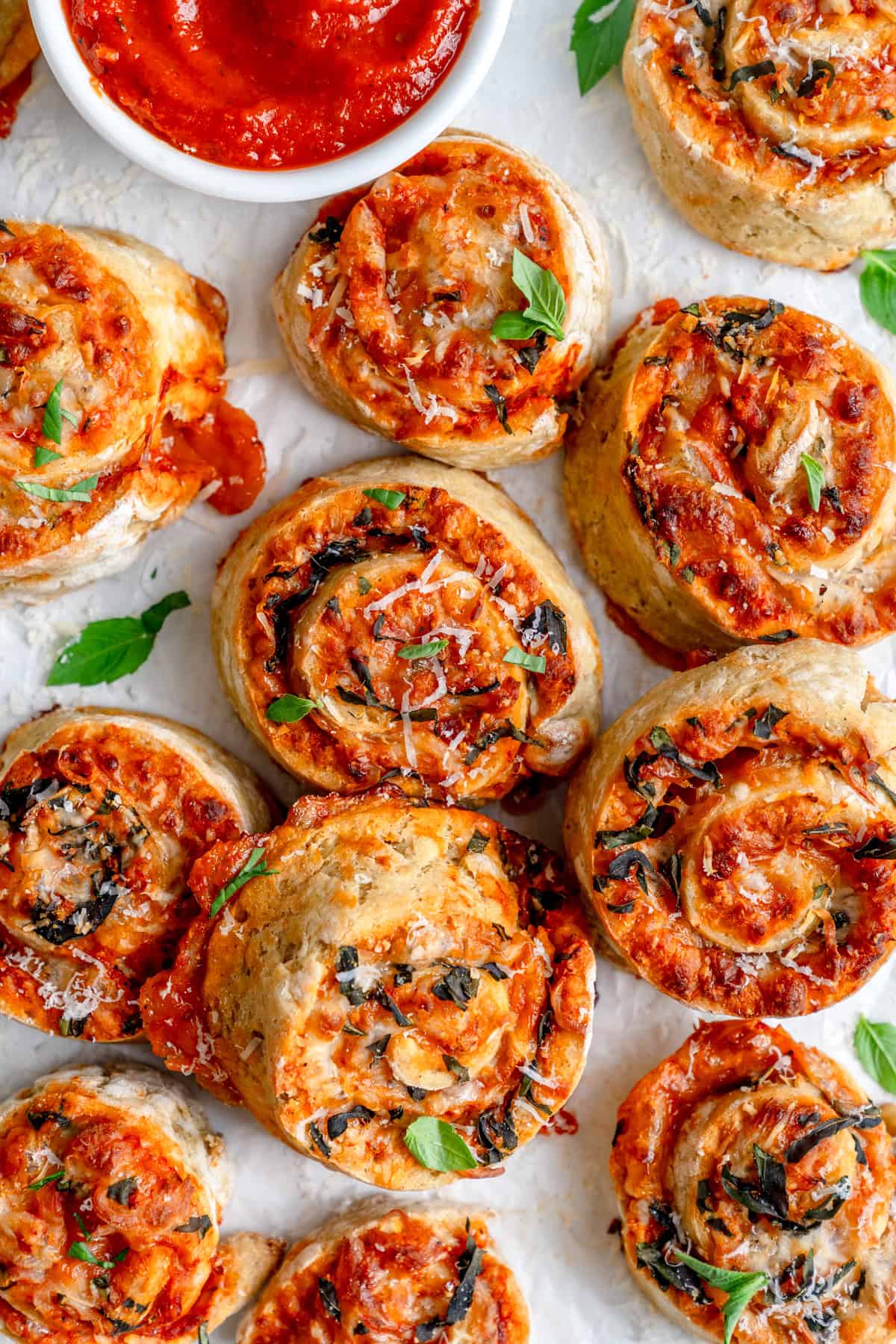 gluten free pizza rolls in pinwheel shape on parchment paper