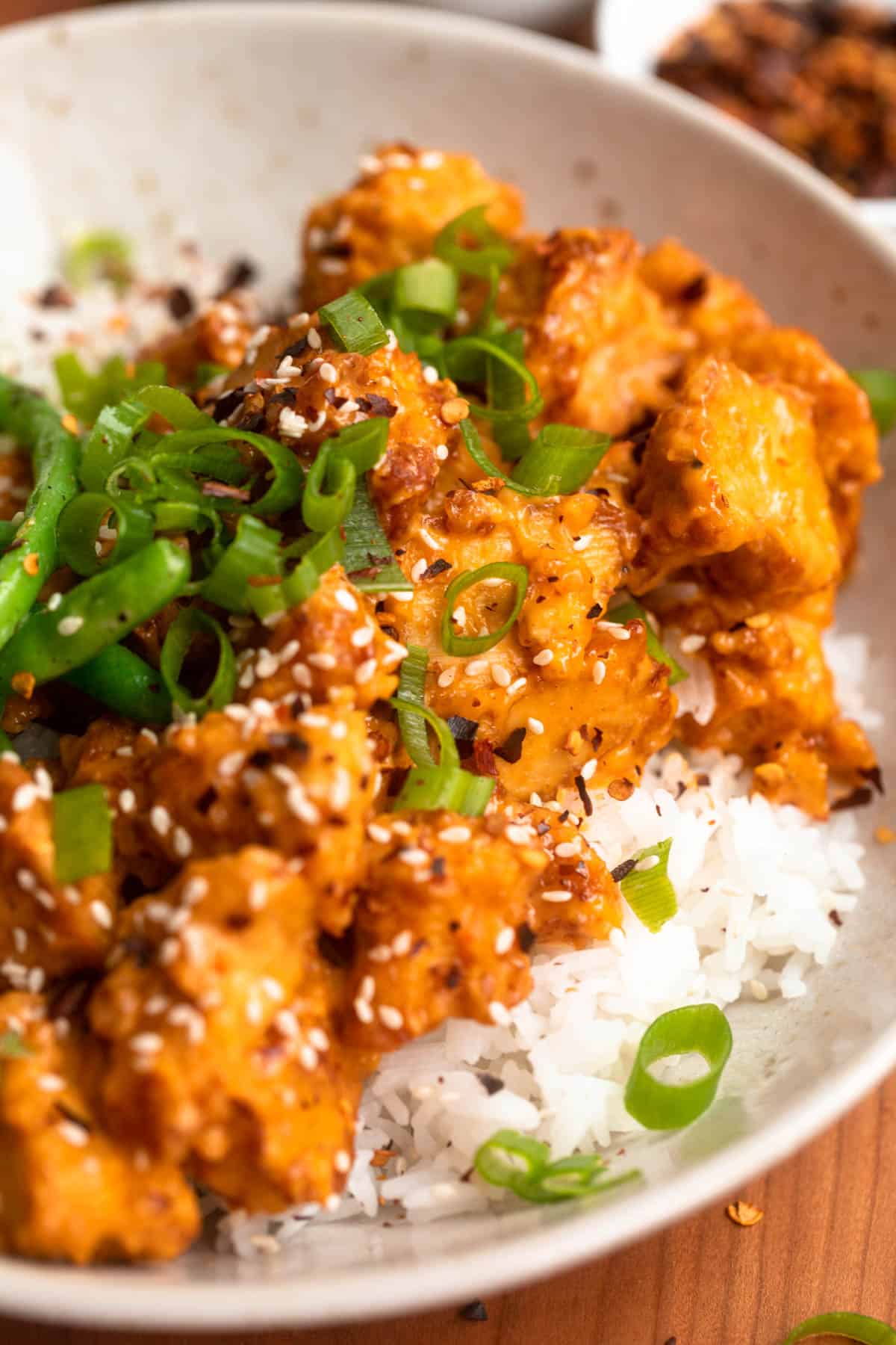 angled view of the bang bang tofu in a bowl with rice and veggies
