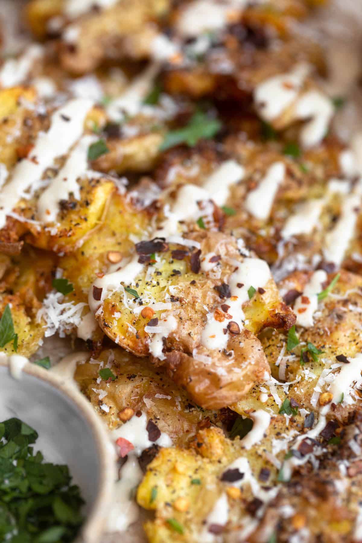 air fryer smashed potatoes with tahini drizzled on top