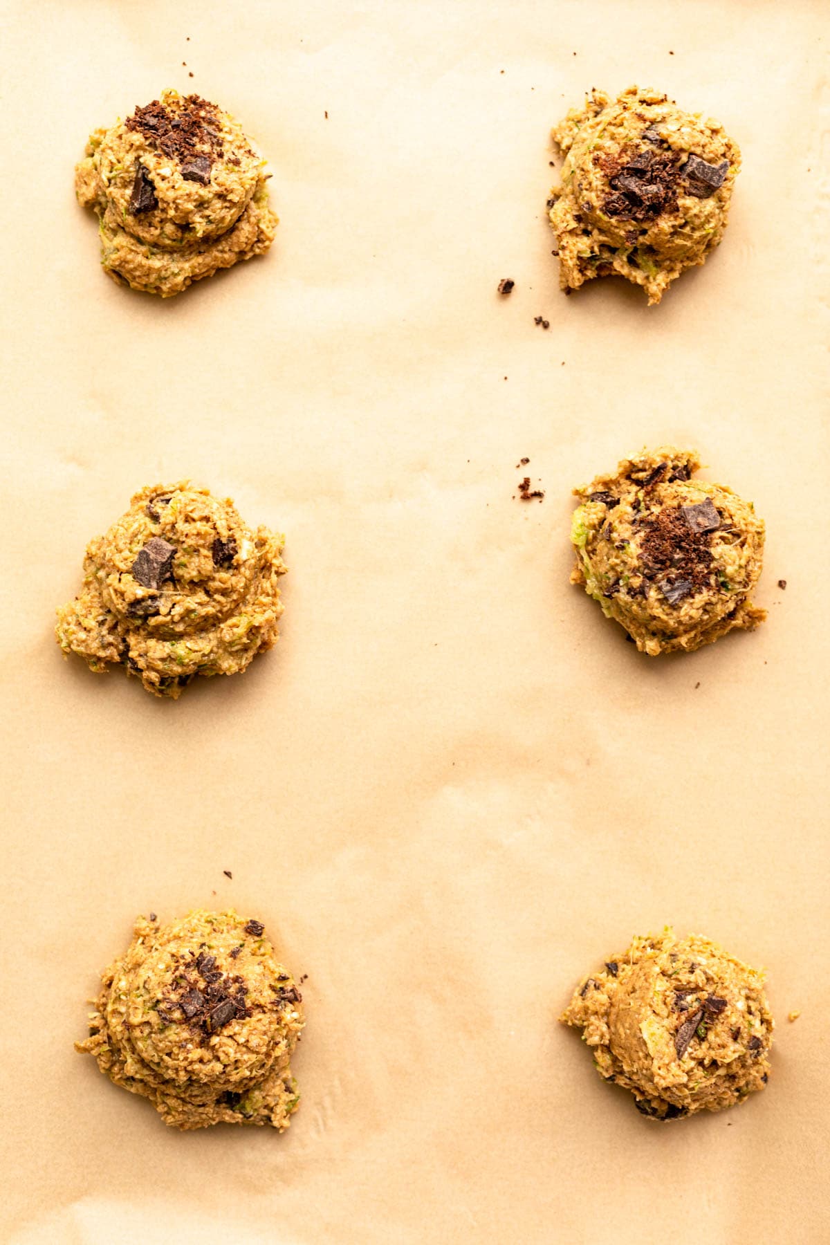 scooped cookie dough on a baking sheet