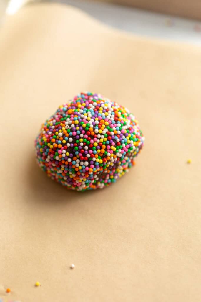 dough scooped into a ball with sprinkles
