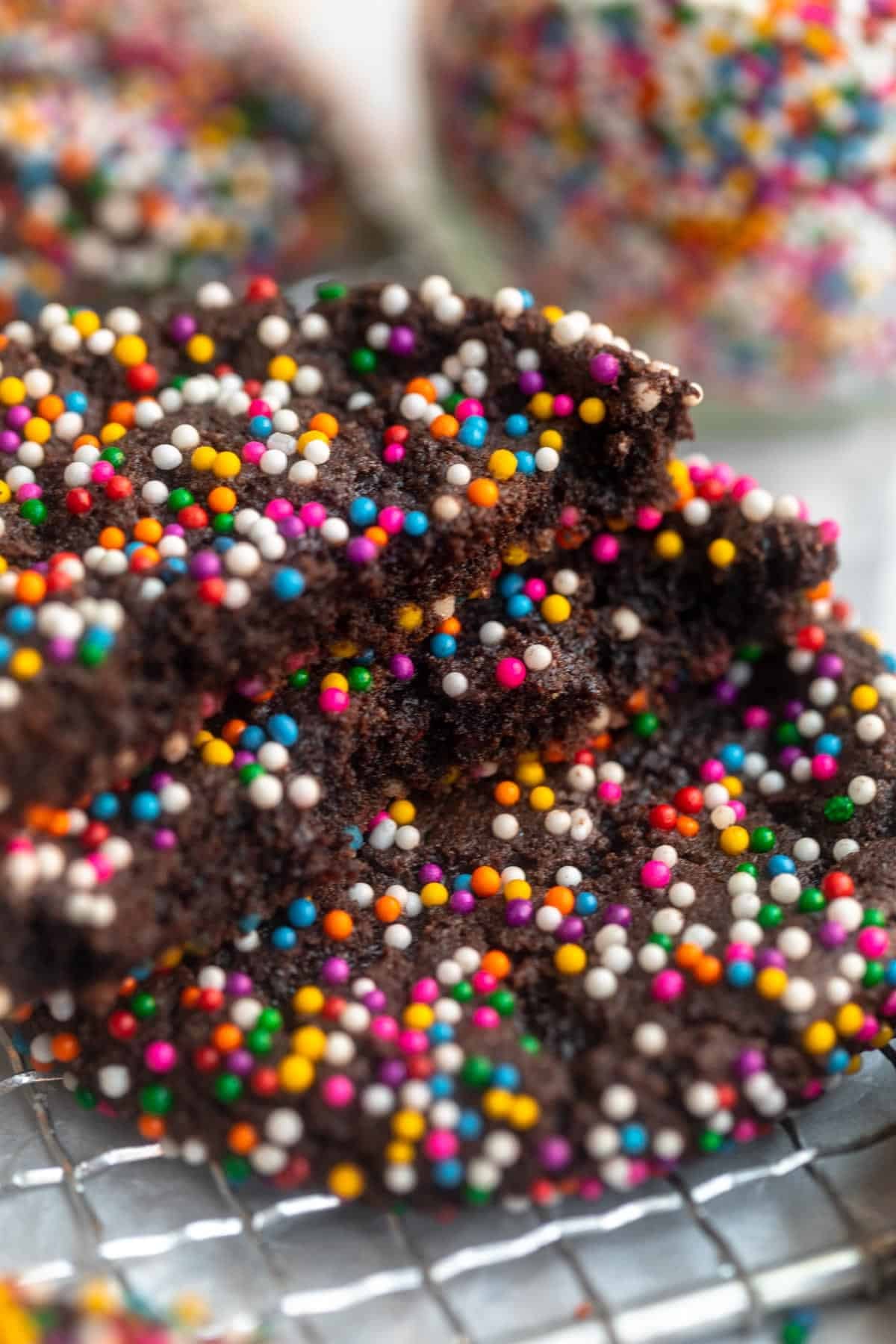 two chocolate sprinkle cookies ripped in half to show texture