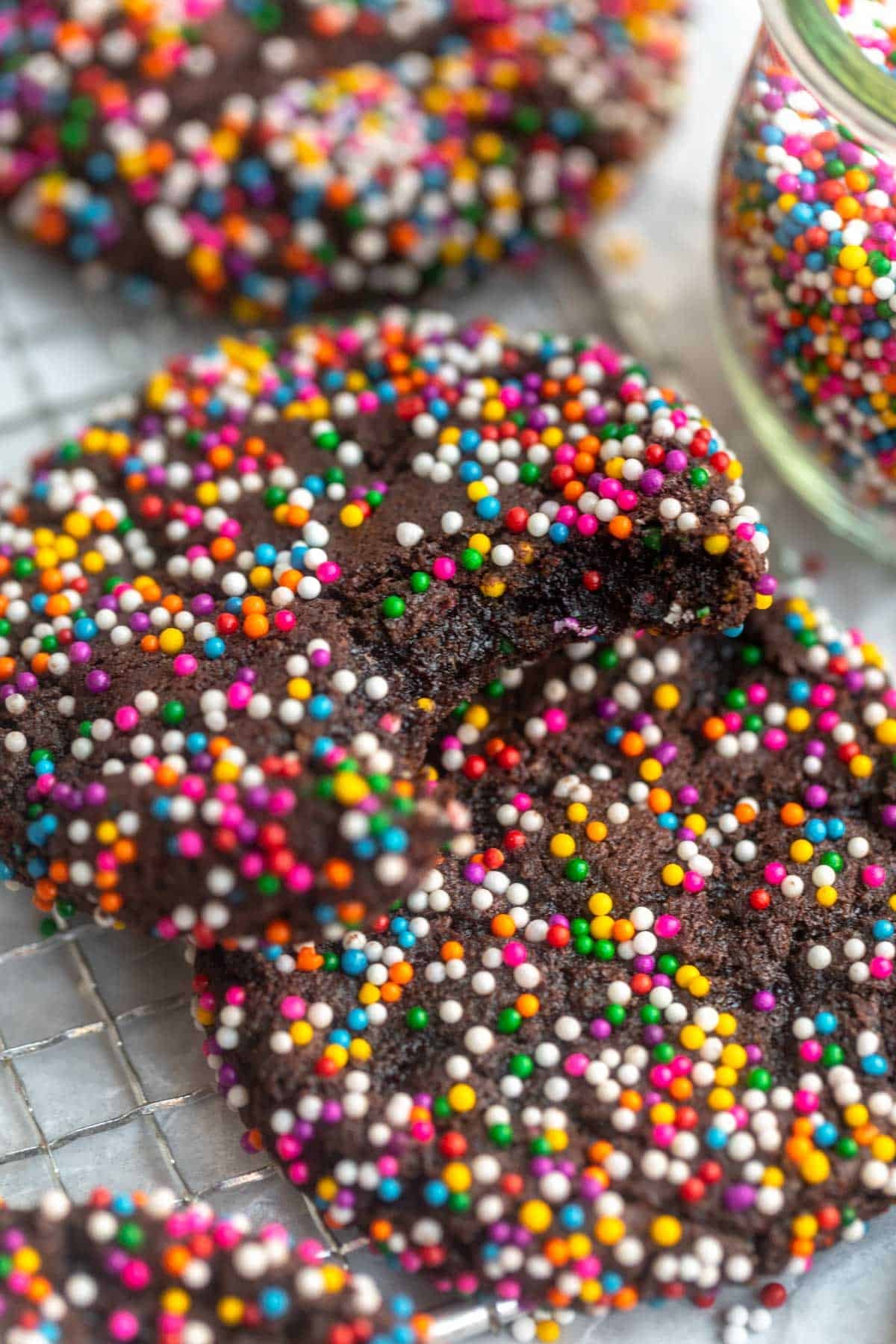 chocolate sprinkle cookies with a bite taken out to show texture
