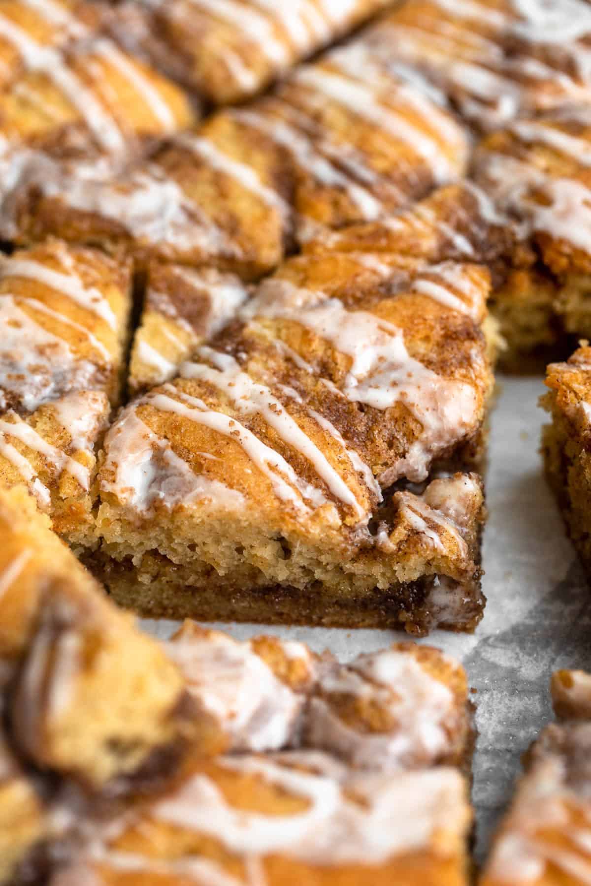 angled view of the cinnamon roll cake with icing on top
