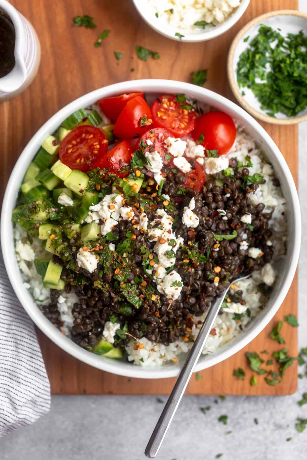 greek lentil bowls with feta and rice with a fork on the side