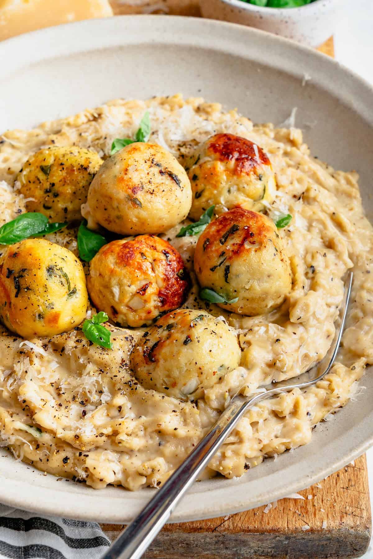 cacio e pep orzo with chicken meatballs and a fork on the side
