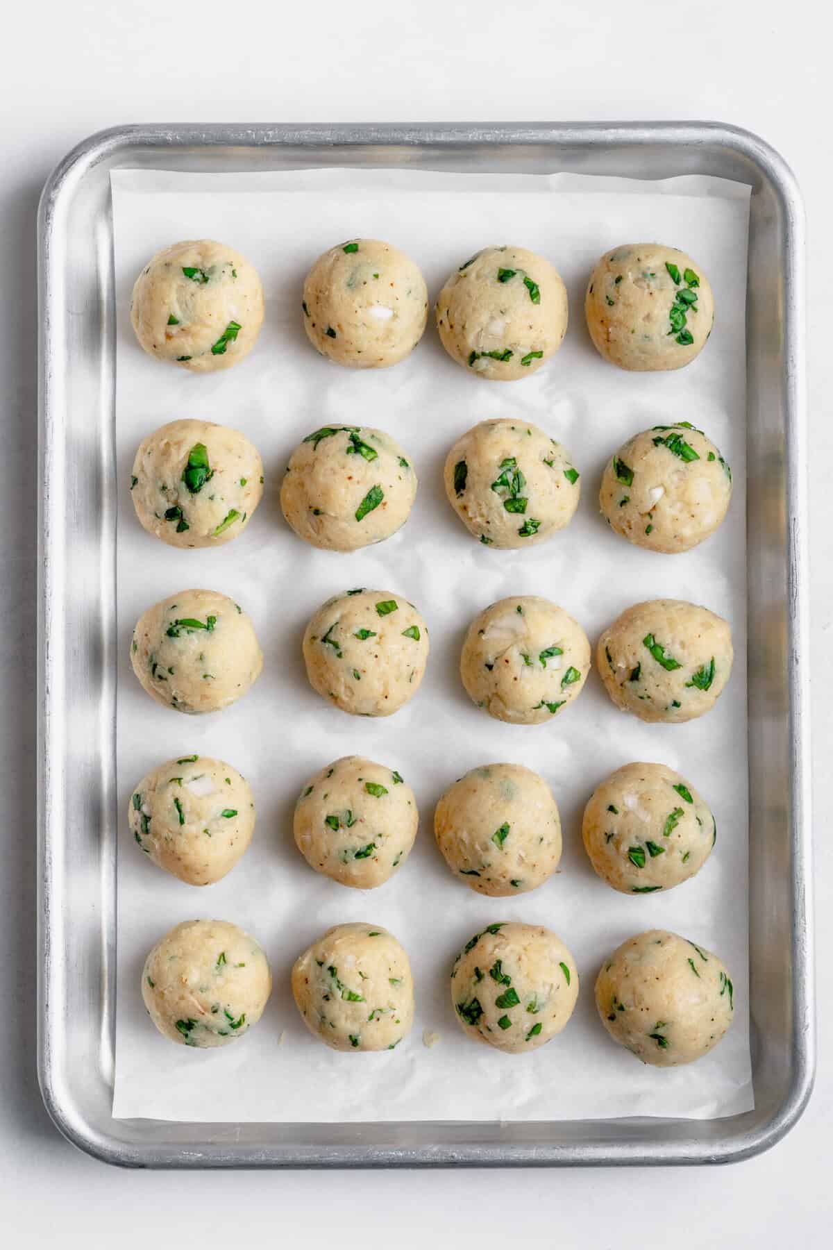 meatballs on a baking sheet before cooking