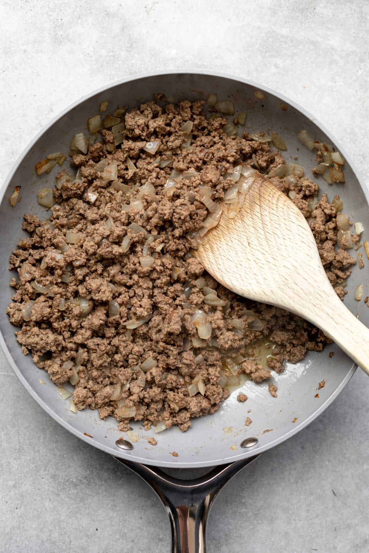cooking the meet with onion in a pan