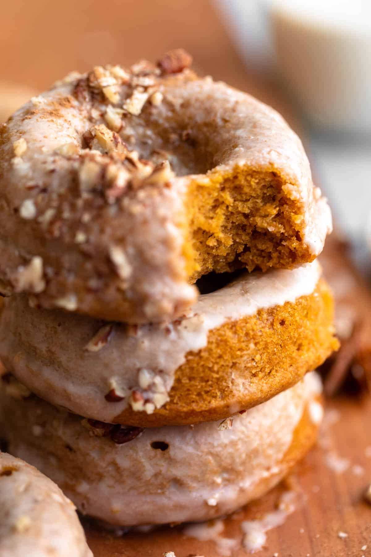 three gluten free pumpkin donuts stacked on each other