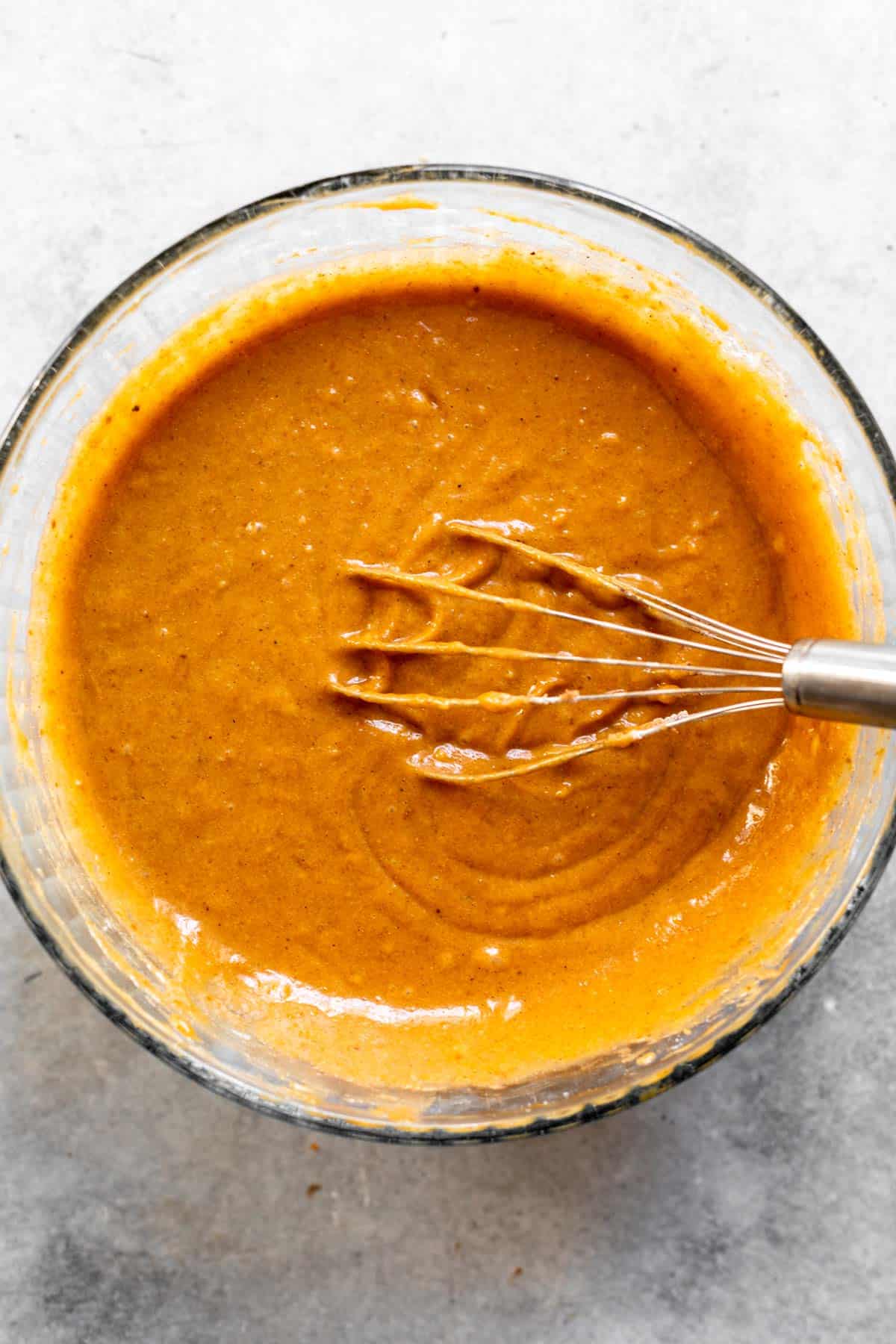 batter in a glass bowl with a whisk
