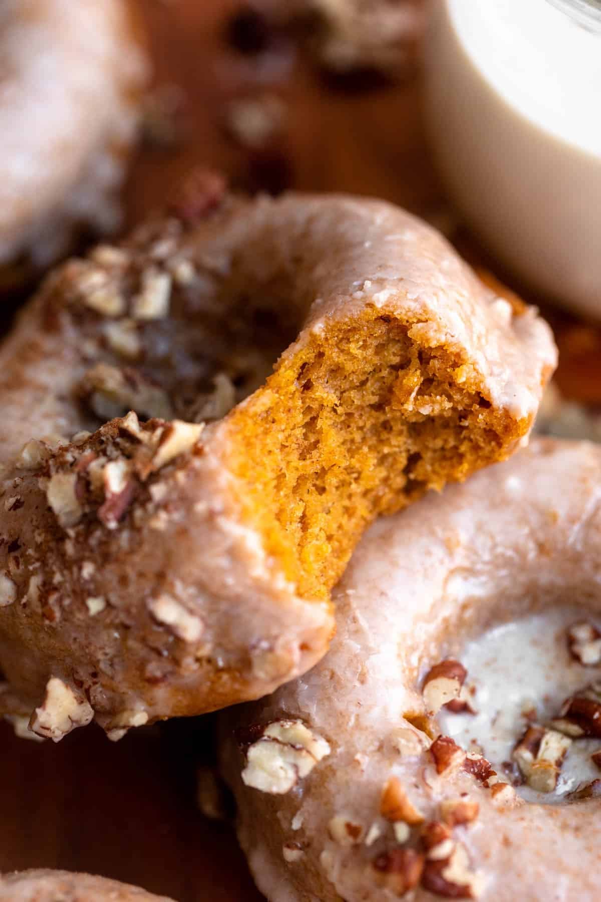 bite taken out of the gluten free pumpkin donut to show texture