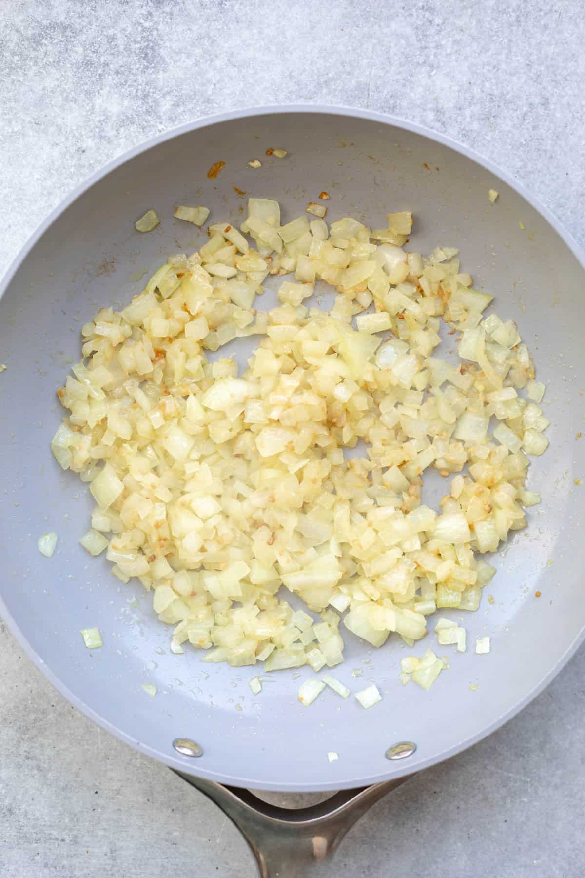 sauteeing the onion in a pan
